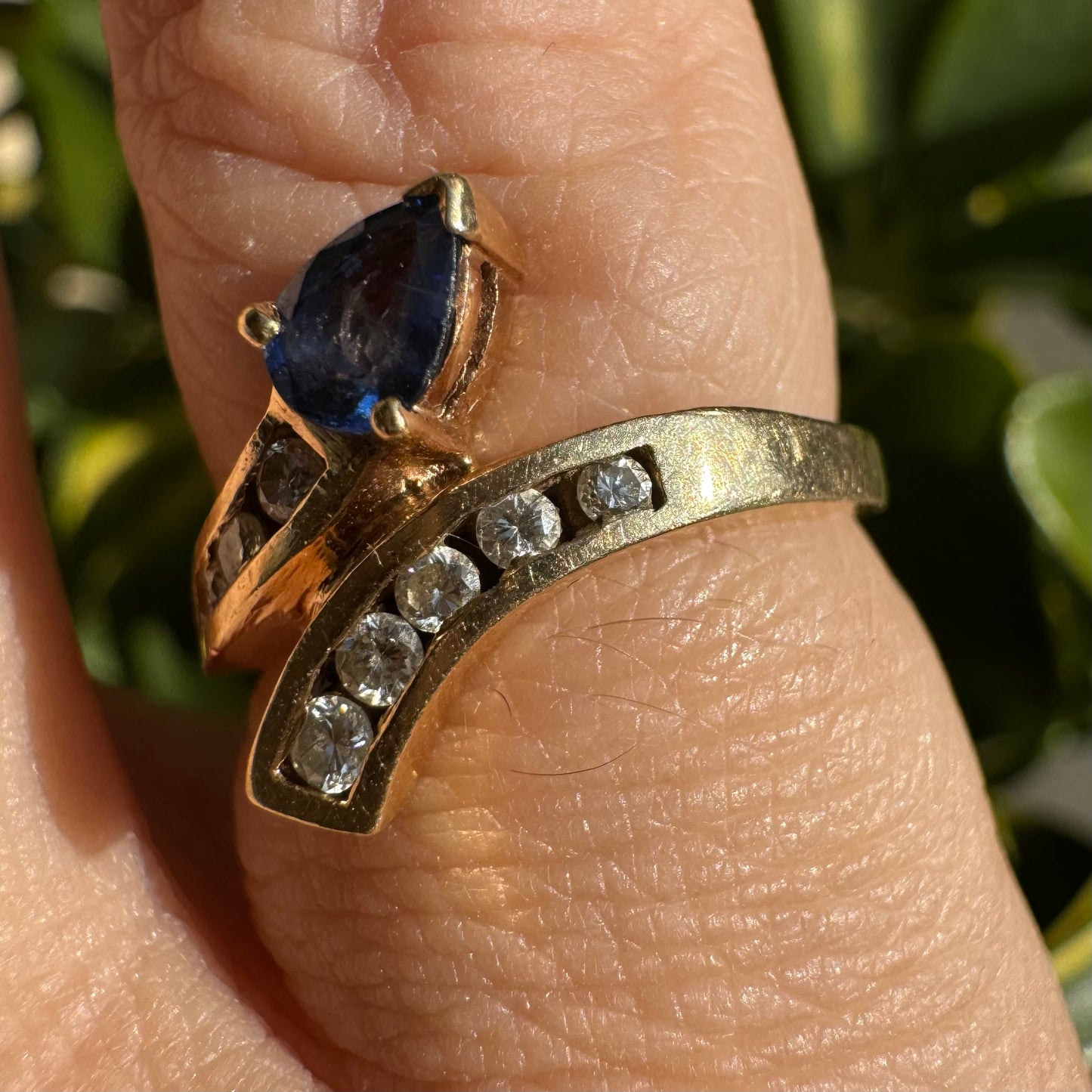 14K gold ring set with a teardrop-shaped Sapphire & Diamonds