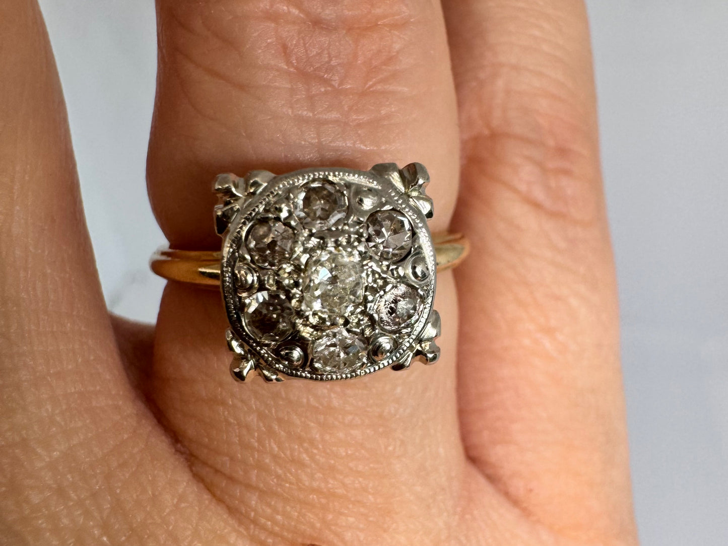 14K gold ring set with an old-cut Diamond at its center, encircled by a pavé cluster of smaller Diamonds in a round, ornate setting.
