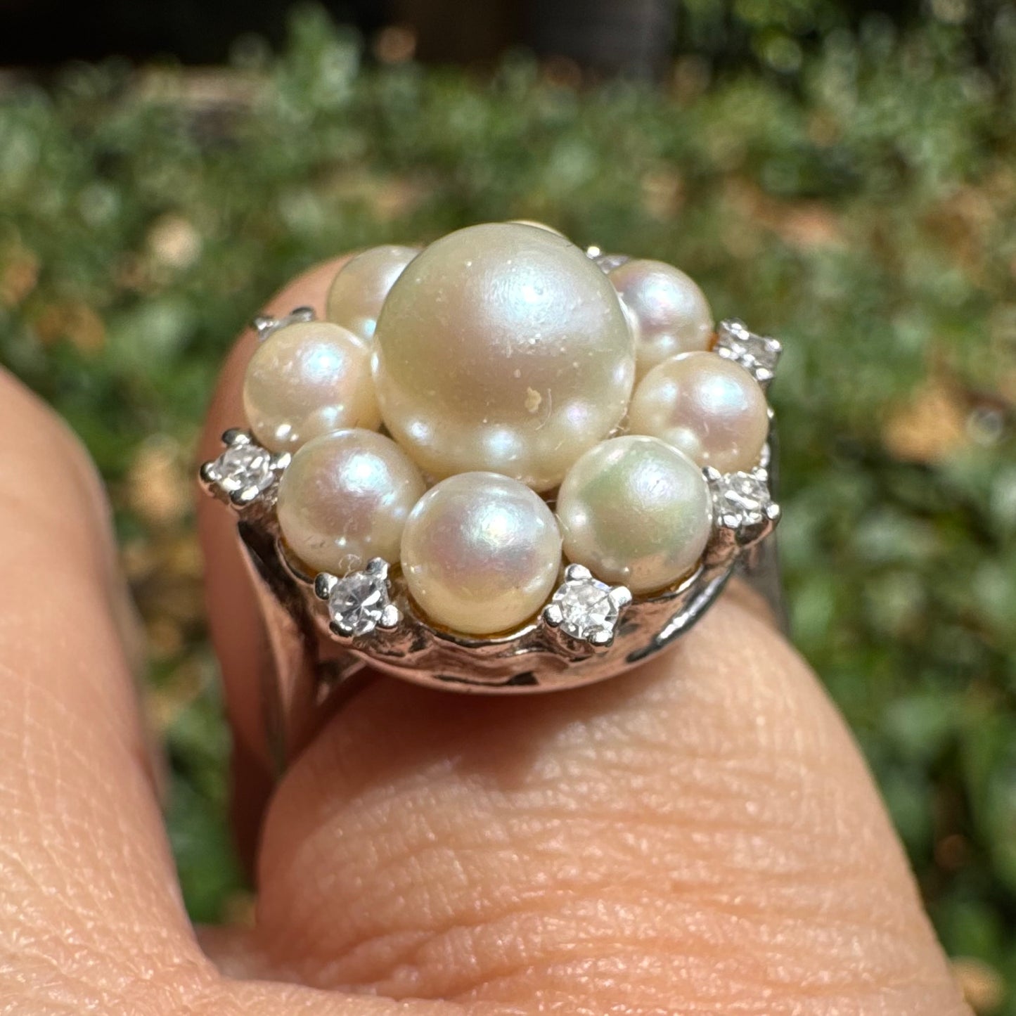 14K gold ring set with a floral cluster of lustrous Pearls in varying sizes, crowned by a central Pearl & surrounded by sparkling Diamond-like accents