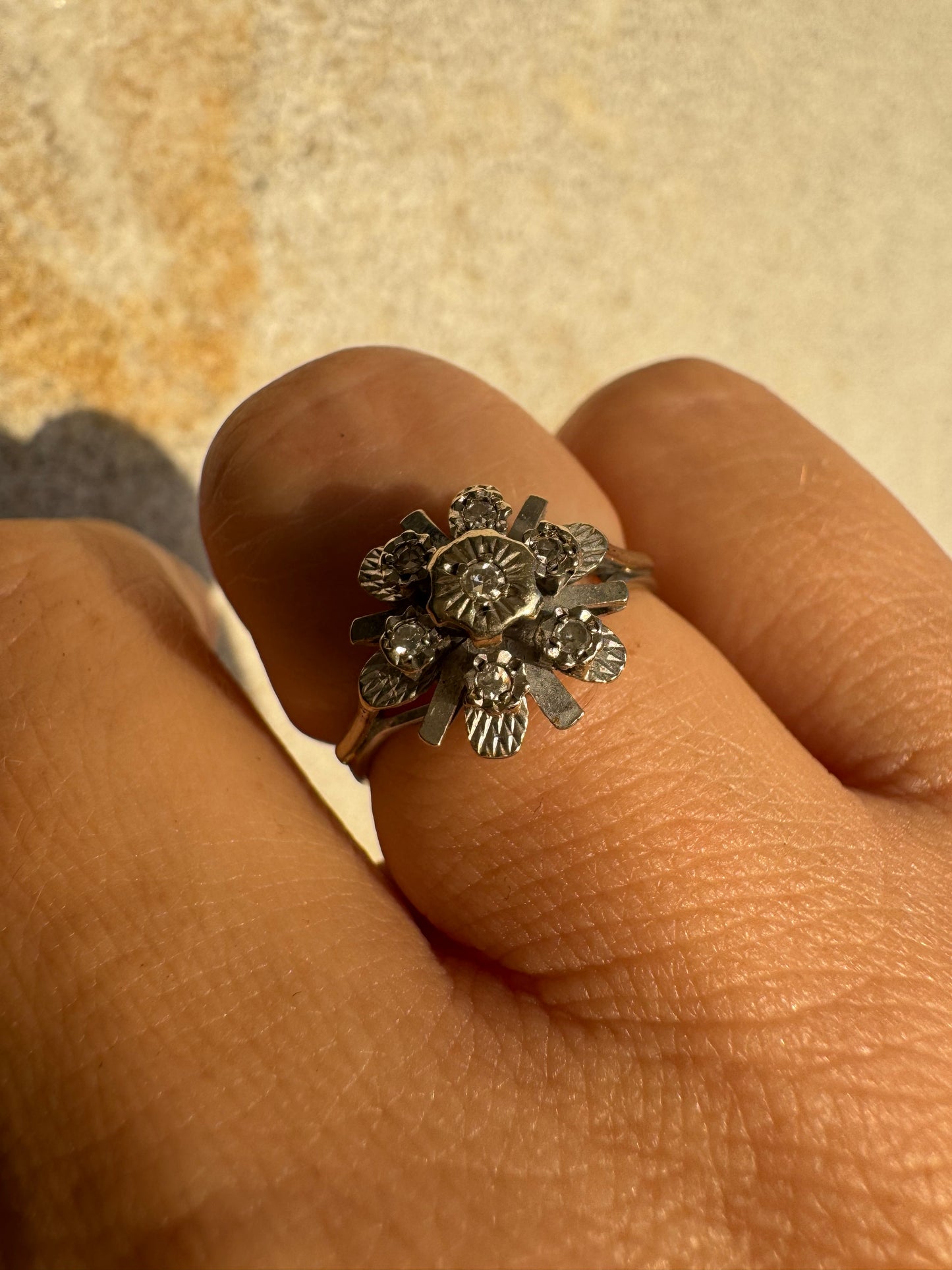 18K gold floral ring adorned with delicate diamond accents