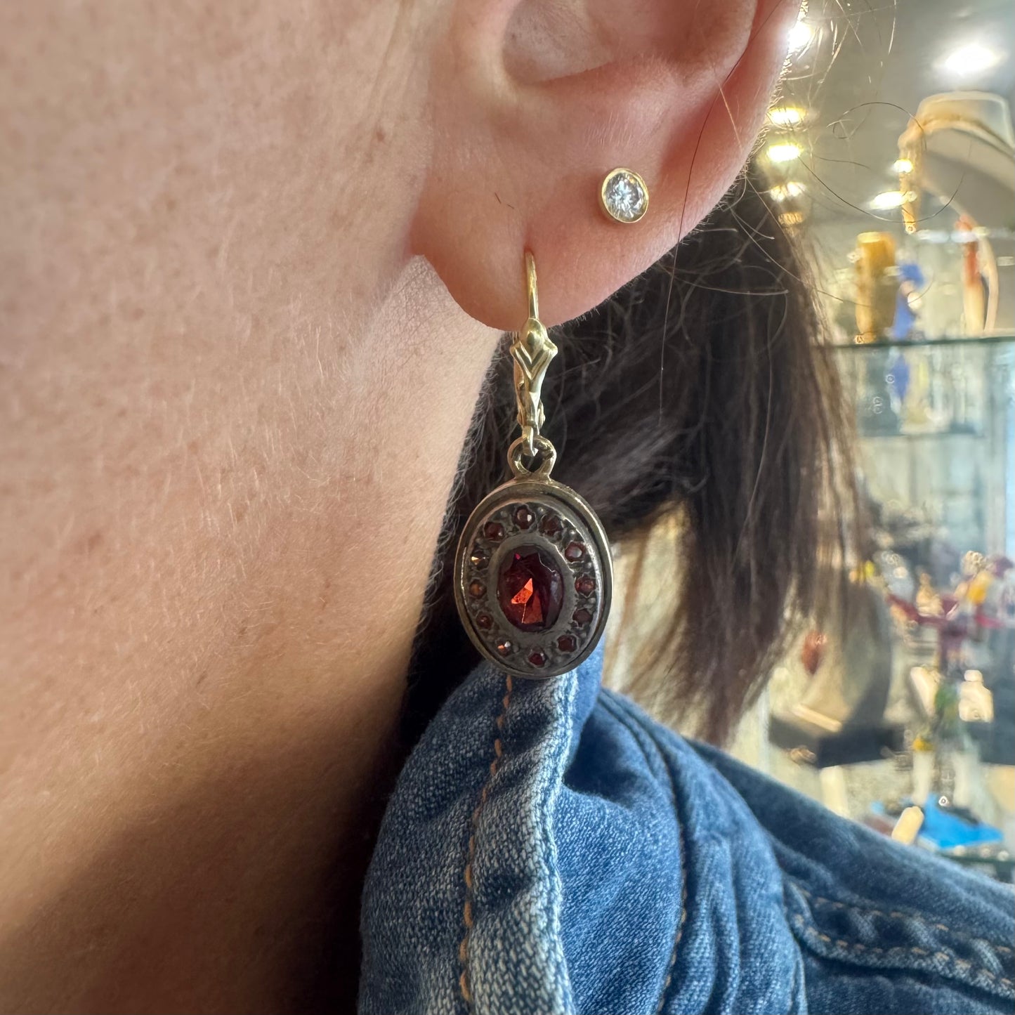 14K gold drop earrings set with deep red oval Garnets surrounded by smaller stones Garnets.
