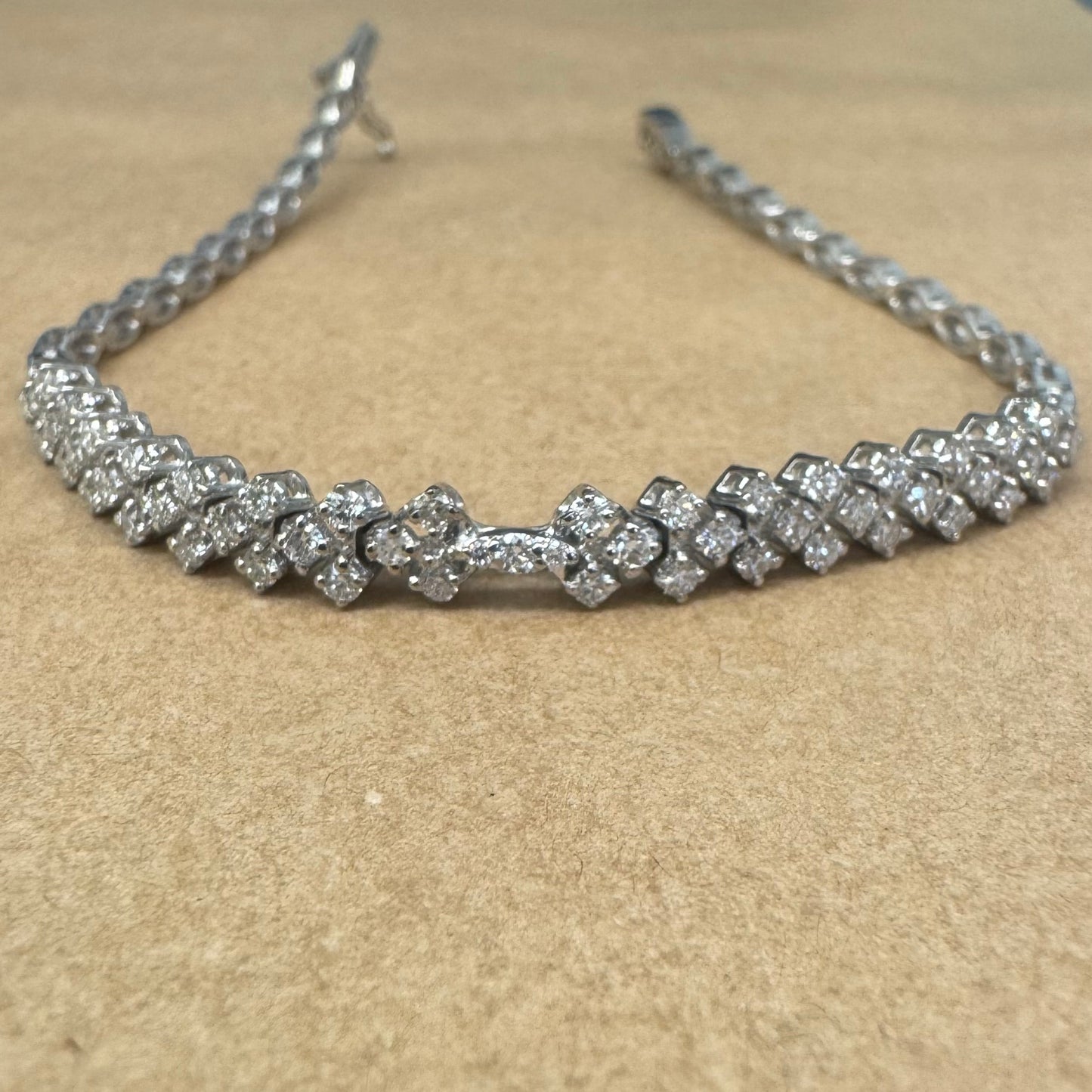 14K white gold bracelet set with sparkling white Diamonds in an elegant floral pattern.