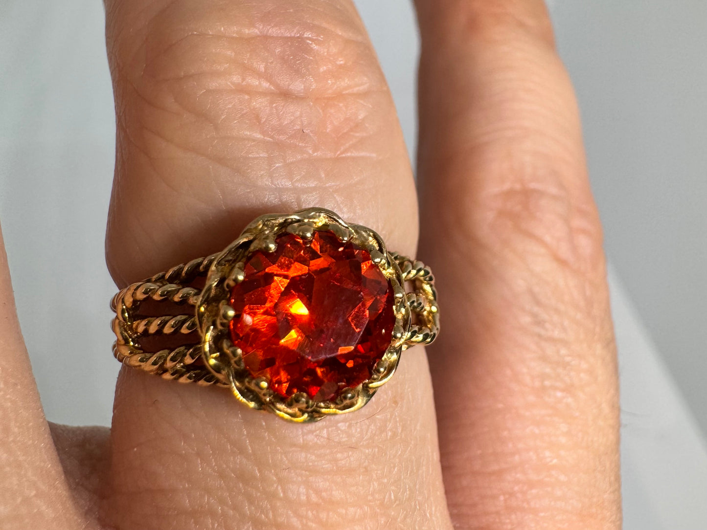 10K gold ring set with a vivid orange gemstone