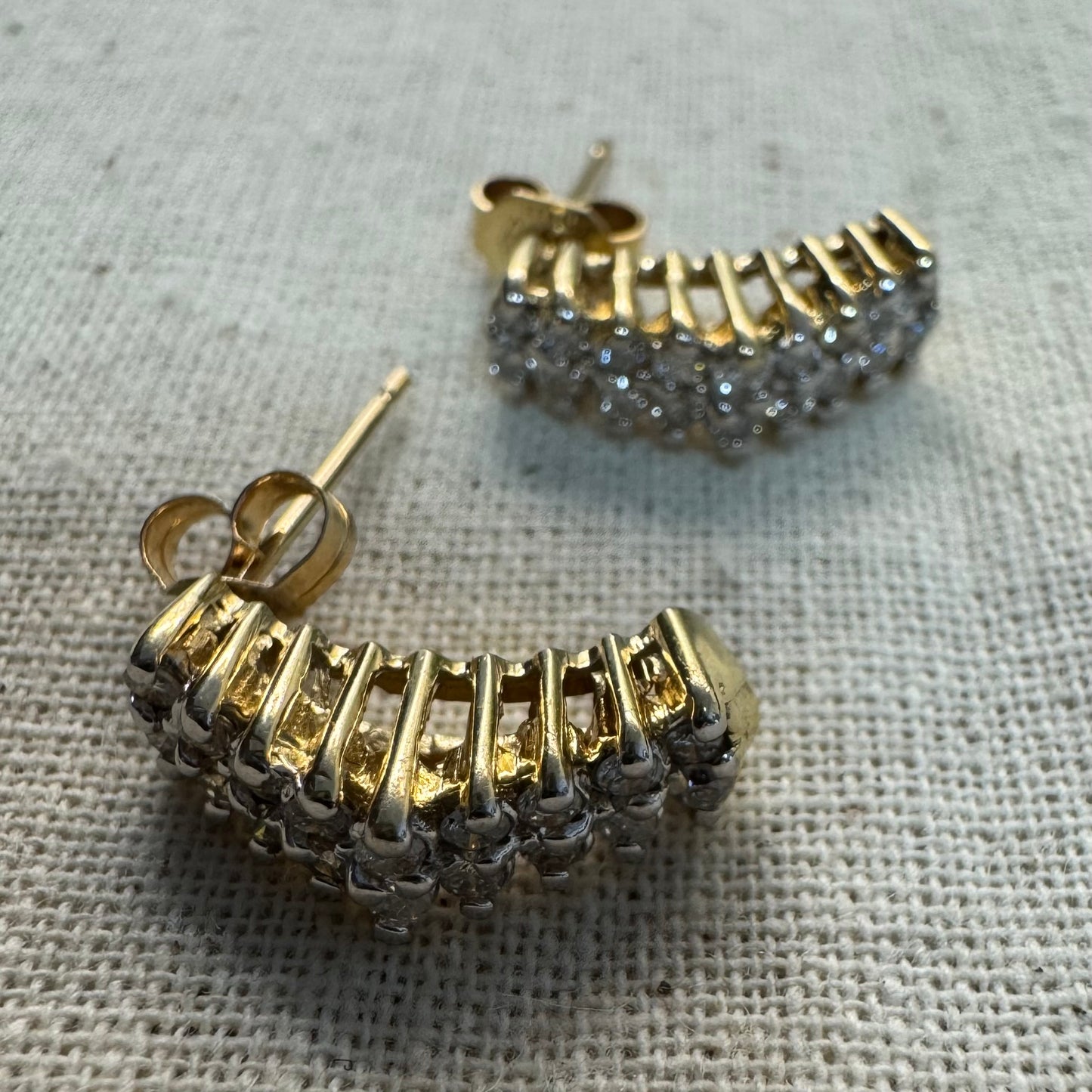 14K gold half-hoop earrings set with sparkling Diamonds in a dense pavé setting