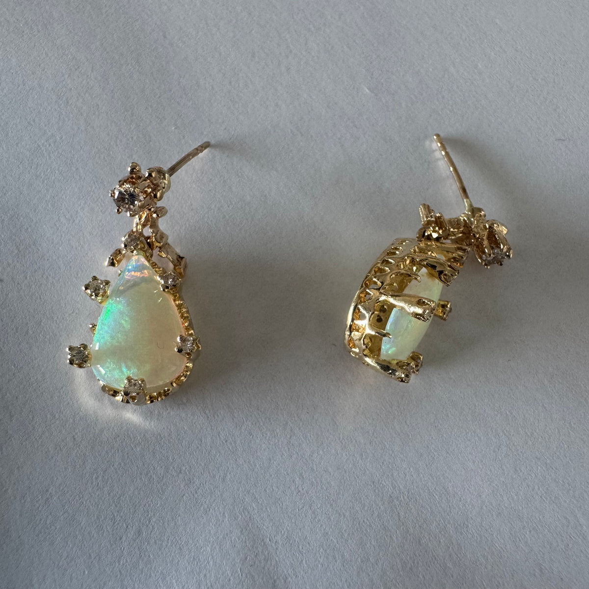 14K gold drop earrings set with pear-shaped Opals and Diamonds.