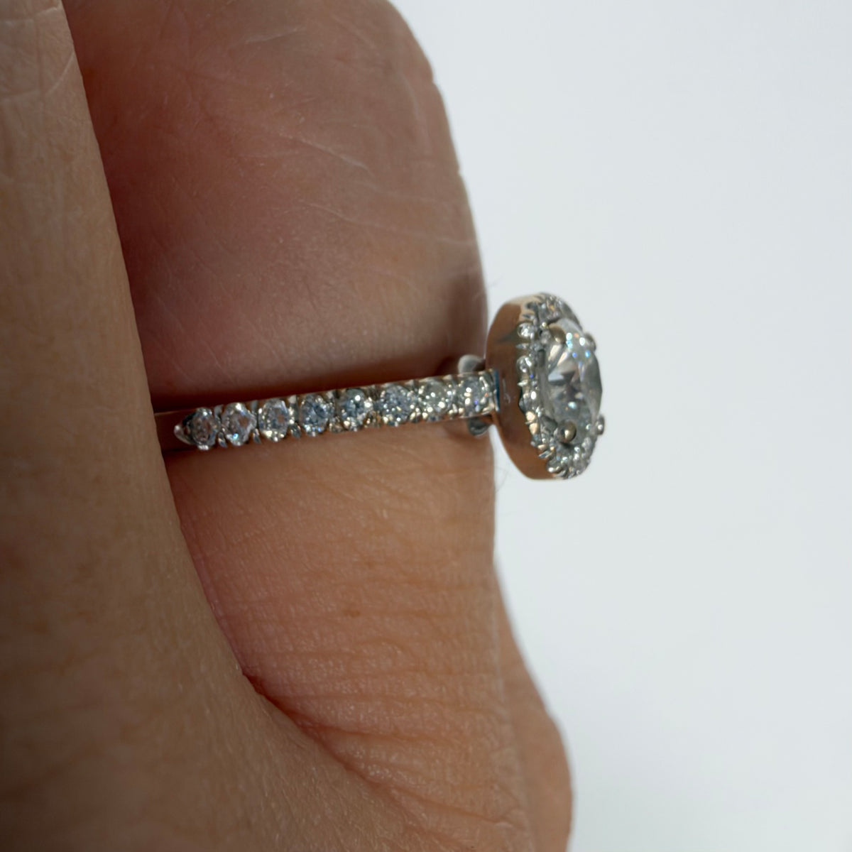 14K white gold vintage ring with a round brilliant-cut diamond and diamond halo