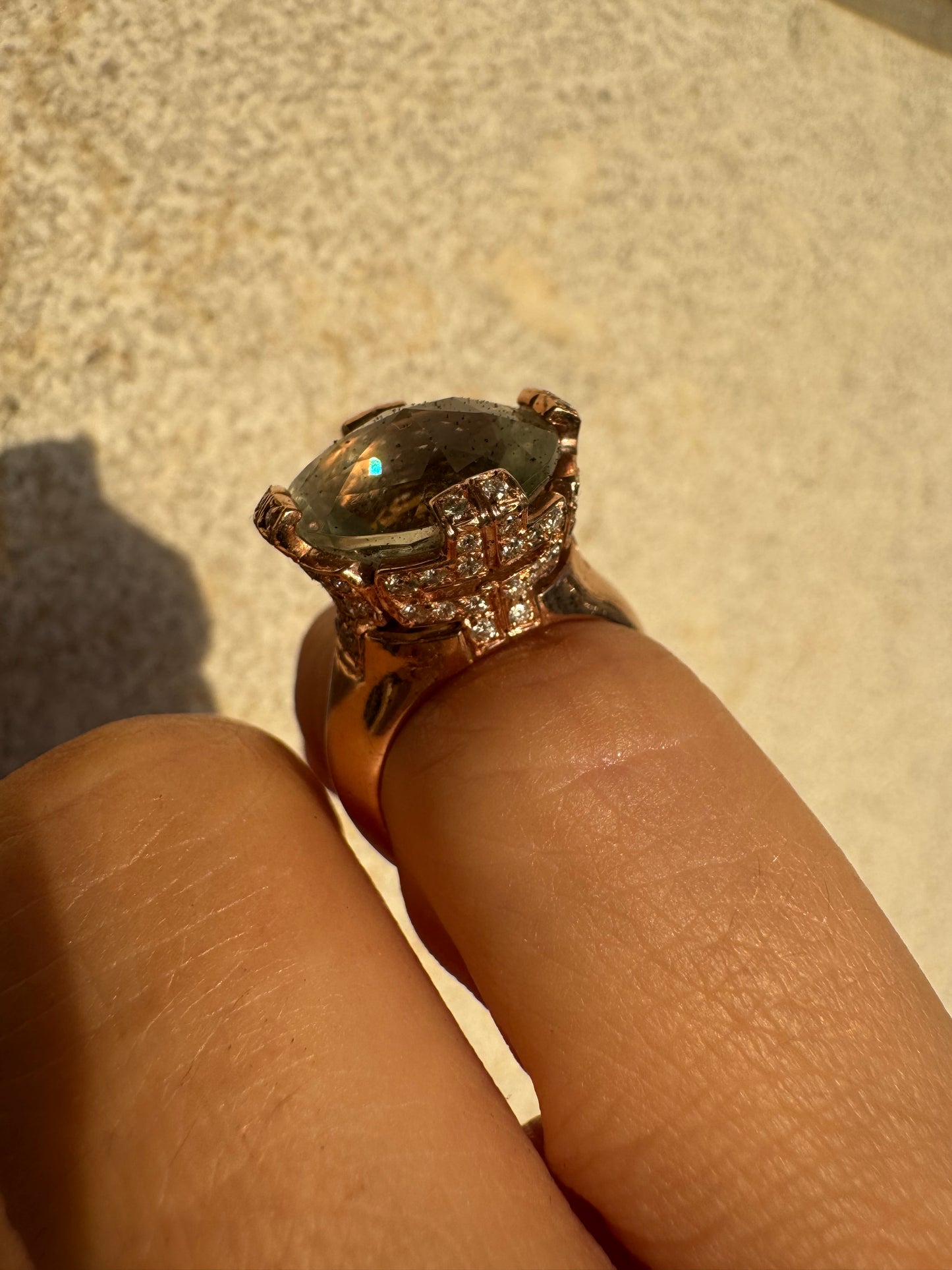 18K gold ring set with a large round Prasiolite gemstone accented by small Diamonds