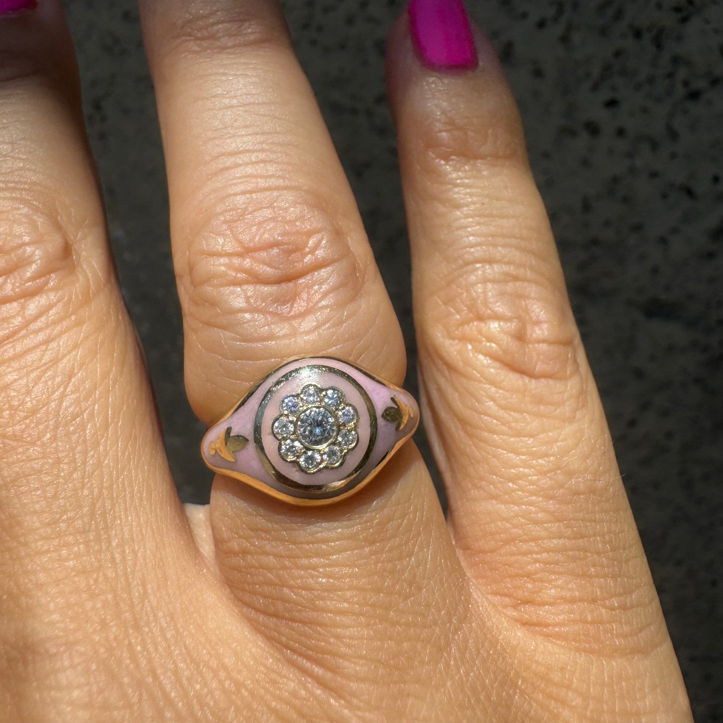 14K gold ring set with soft pink enamel & Diamonds with floral motif at the center.