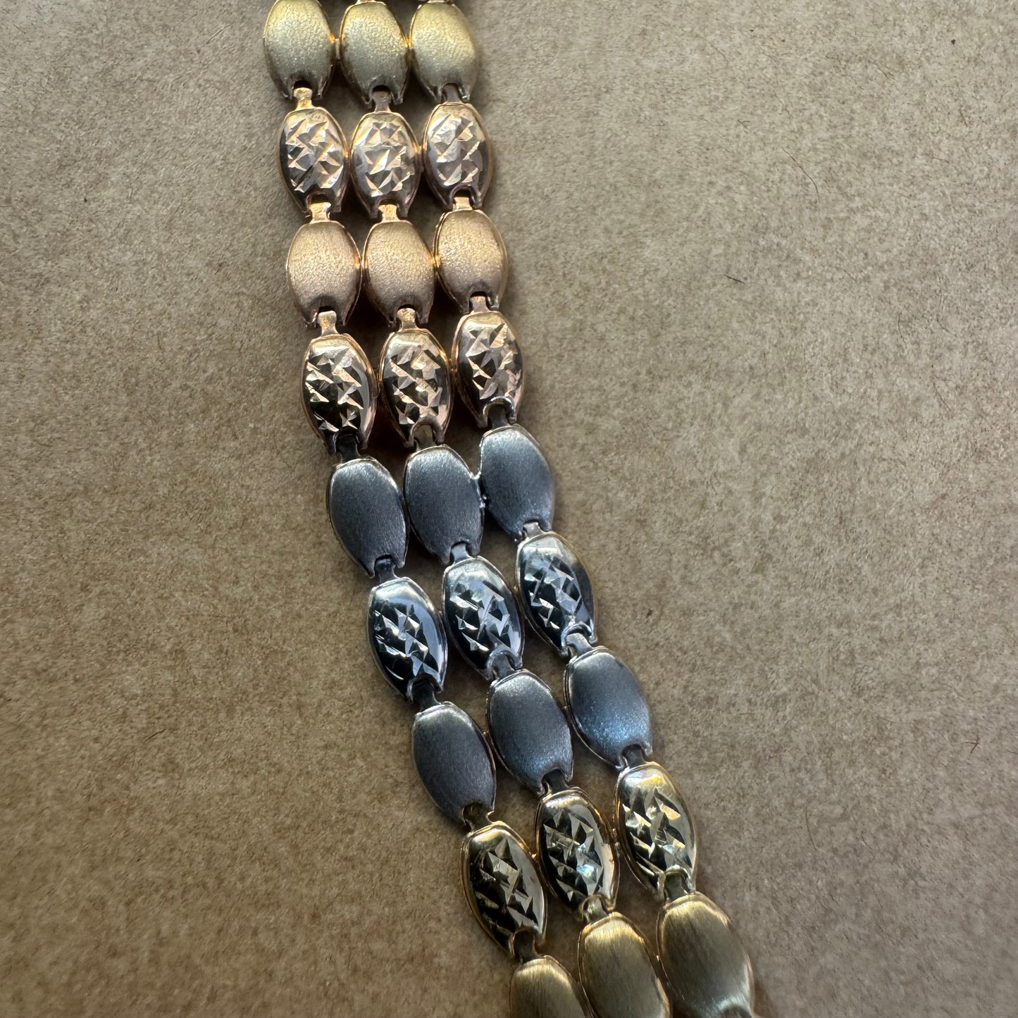 14K tri-color gold bracelet featuring yellow, white and rose gold links