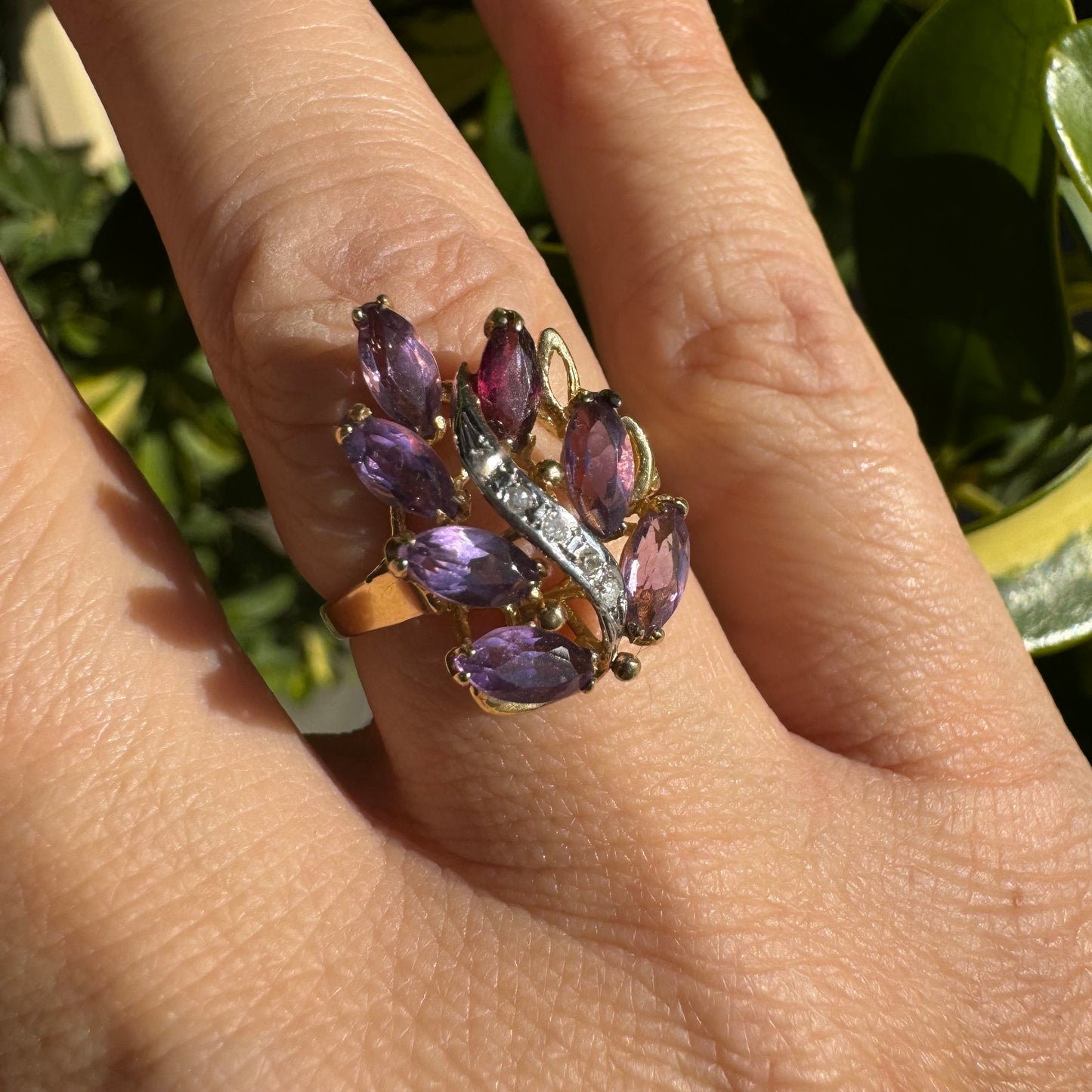 14K gold ring designed in a leaf motif, set with 7 marquise-cut Amethyst and accented by a curved line of sparkling Diamonds