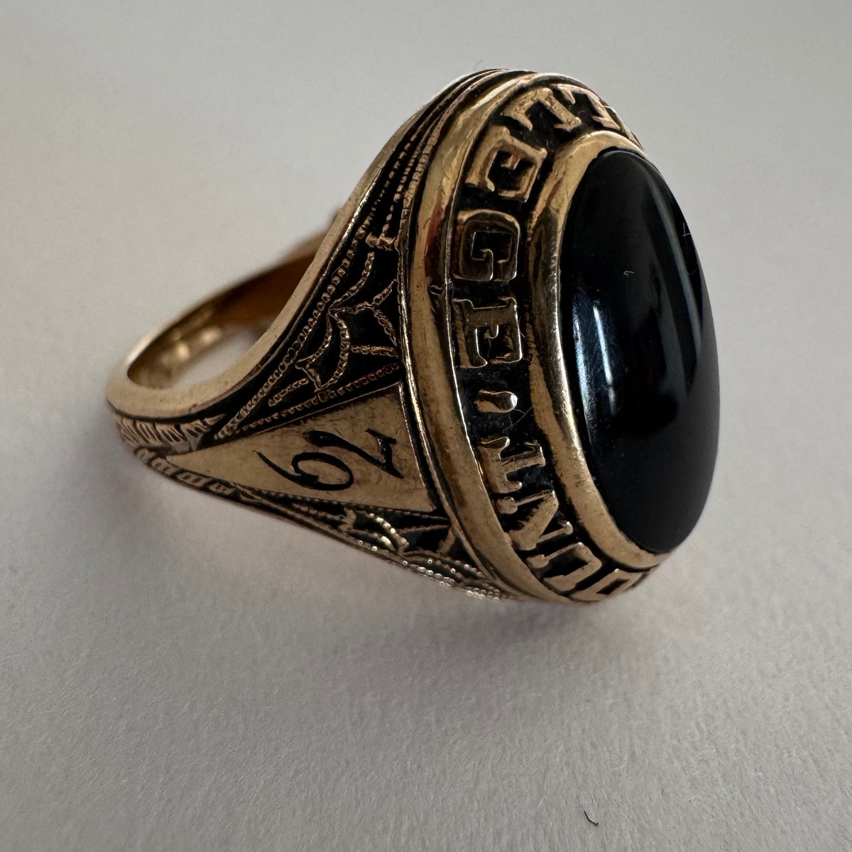 10K gold signet-style ring featuring an oval black Onyx centerpiece