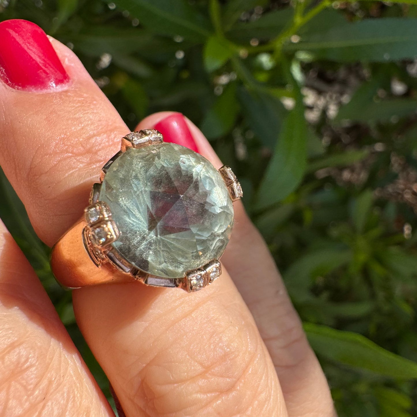 18K gold ring set with a large round Prasiolite gemstone accented by small Diamonds
