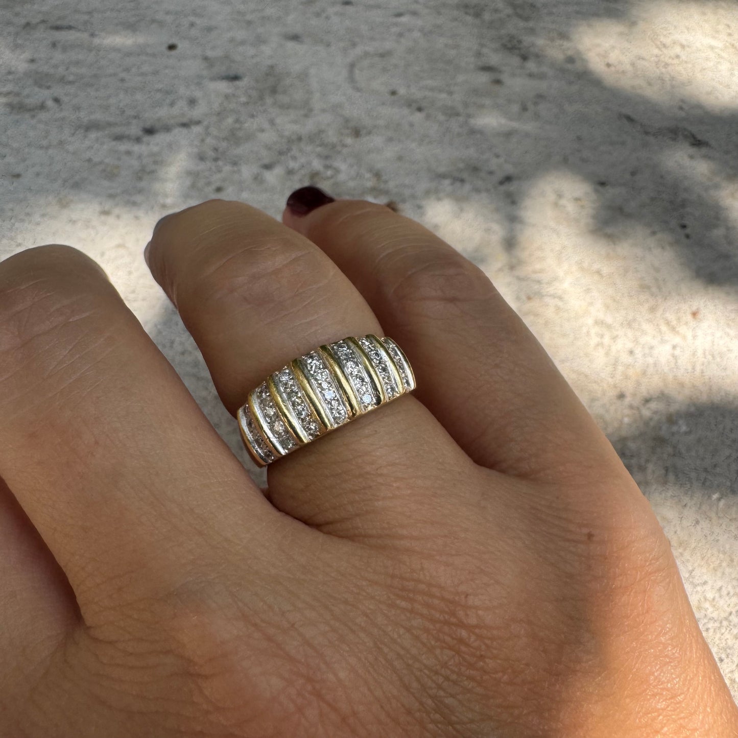 18K gold ring featuring multiple horizontal rows of sparkling Diamonds.