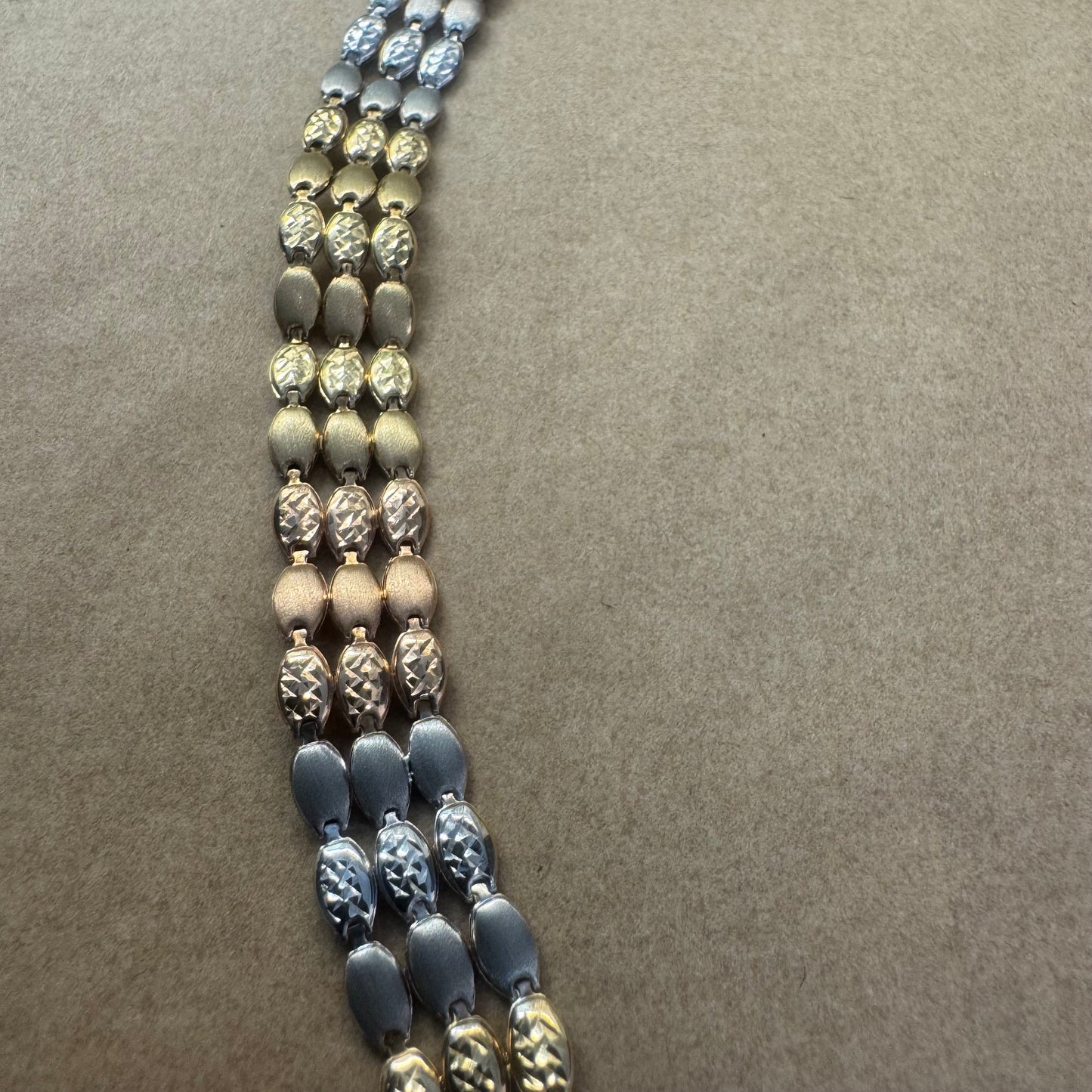 14K tri-color gold bracelet featuring yellow, white and rose gold links