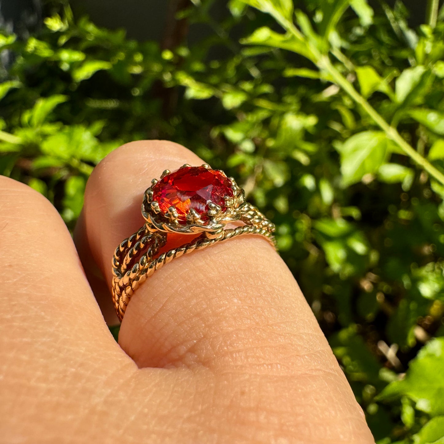 10K gold ring set with a vivid orange gemstone