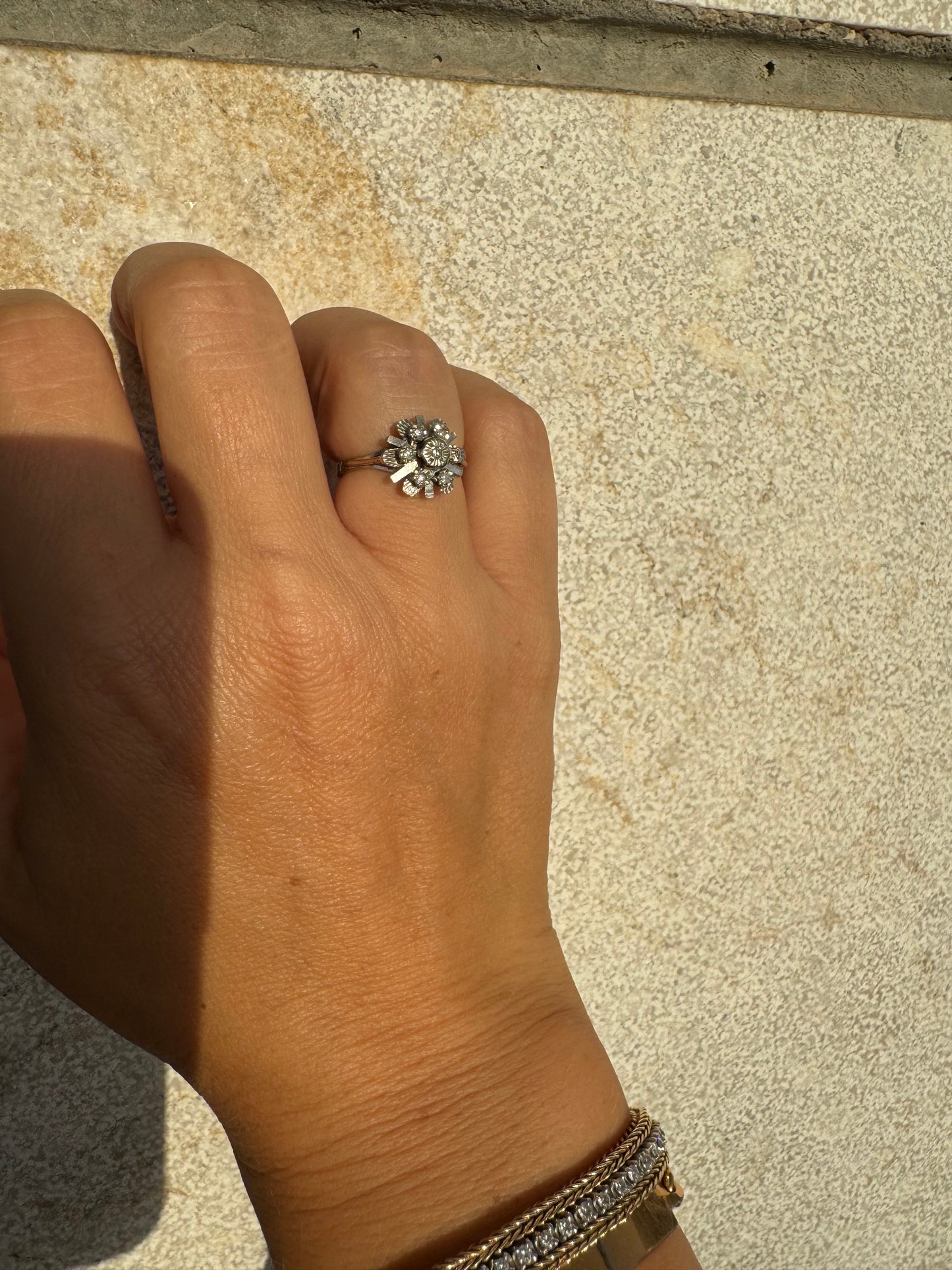 18K gold floral ring adorned with delicate diamond accents