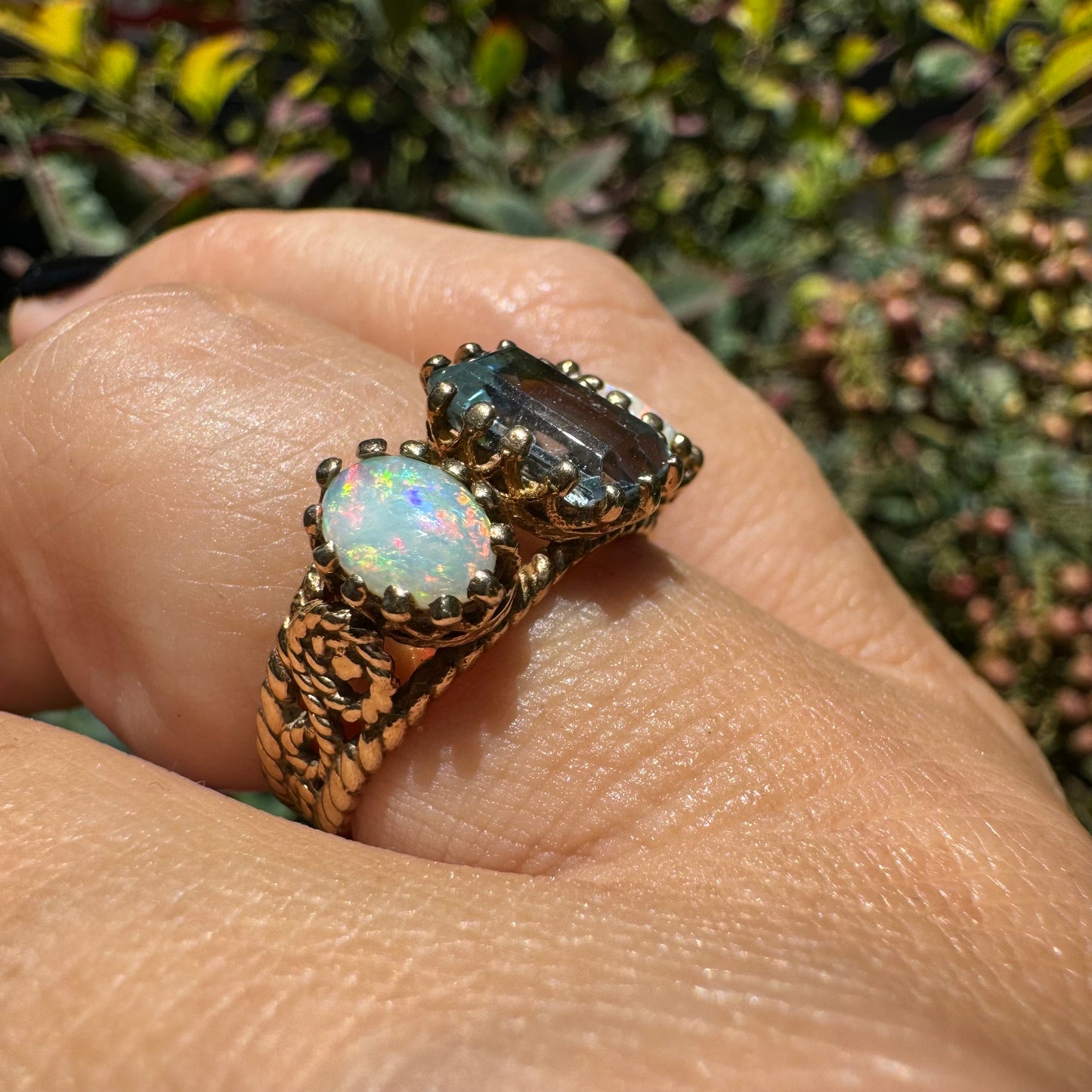 10K gold ring set with a light blue Aquamarine flanked by two dreamy Opals