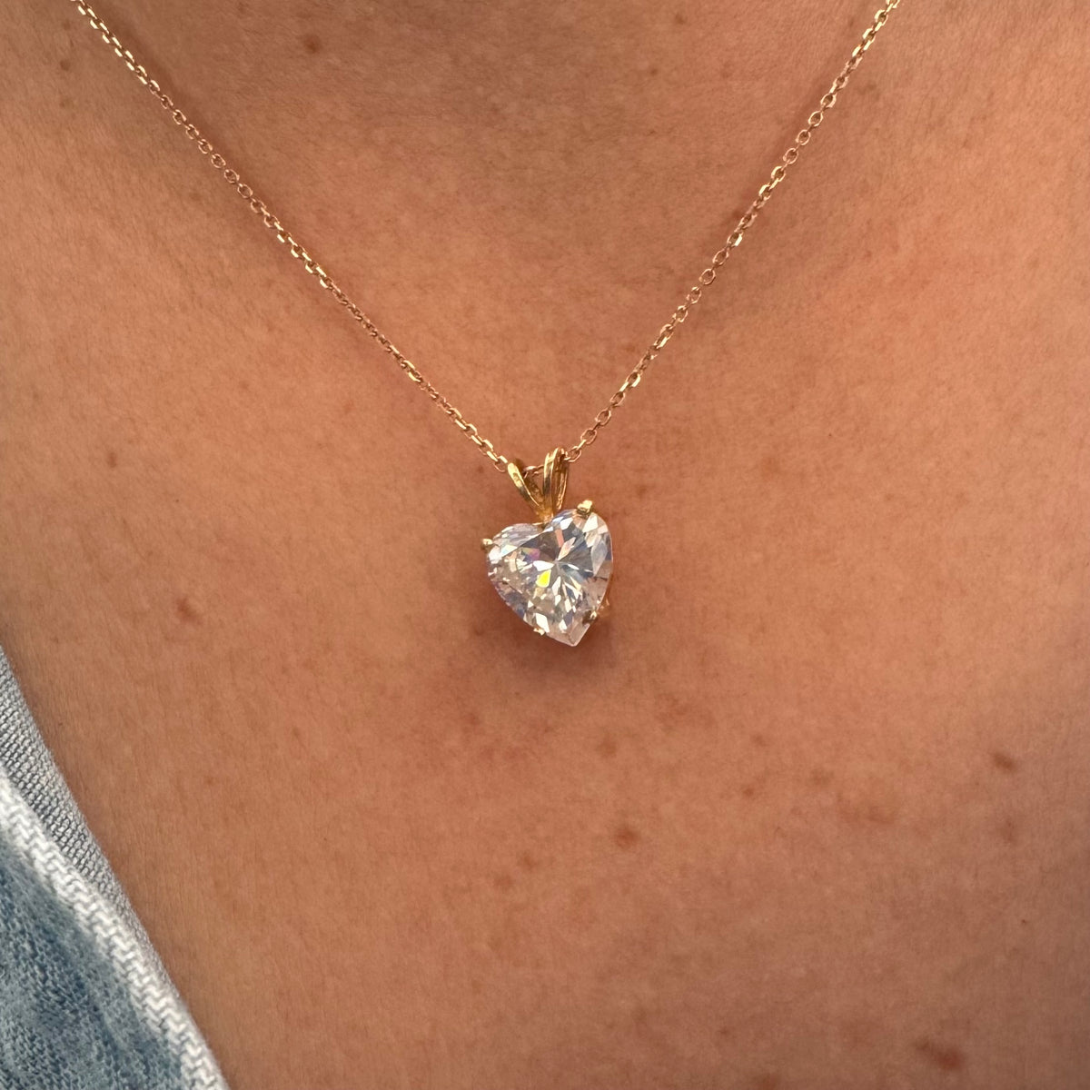 14K gold Heart Pendant set with a brilliant heart-cut clear stone.