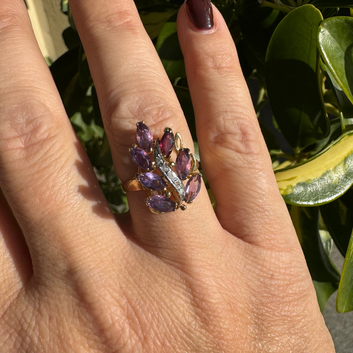 14K gold ring designed in a leaf motif, set with 7 marquise-cut Amethyst and accented by a curved line of sparkling Diamonds