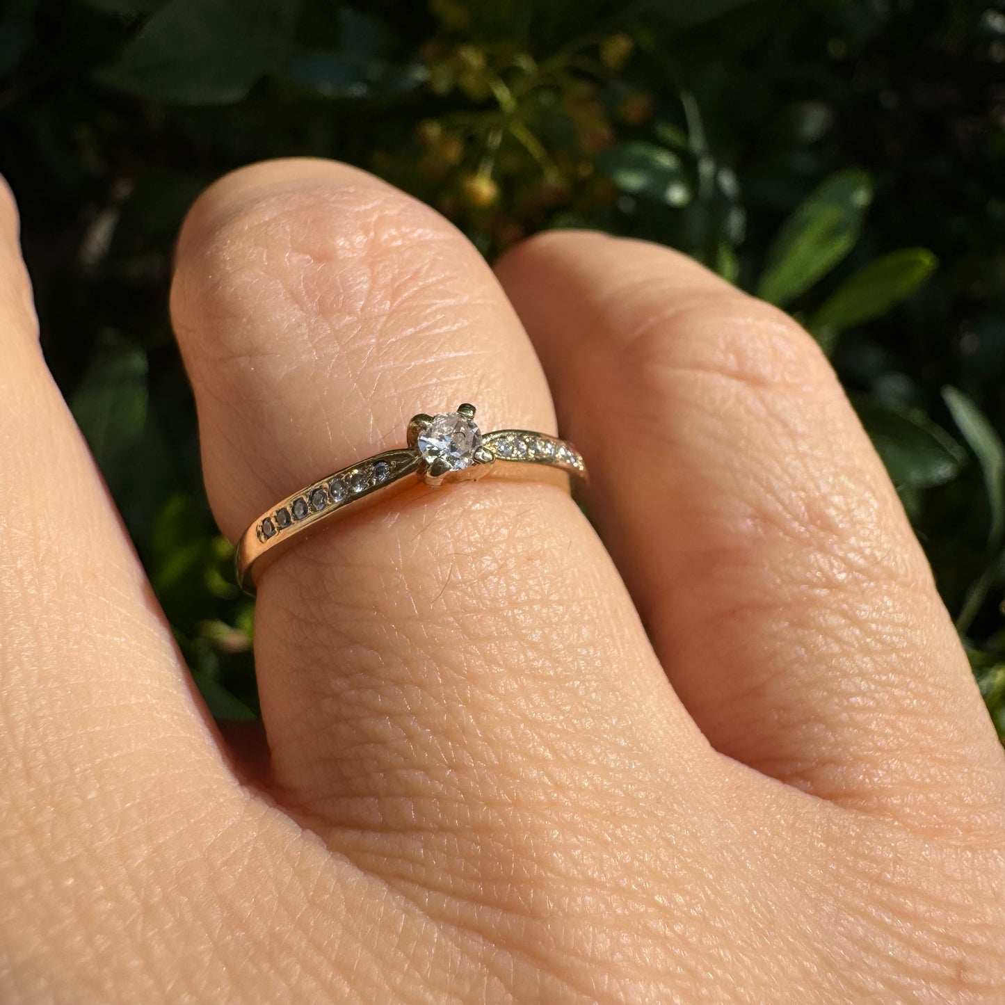 14K gold ring set with one center Diamond and side Diamonds