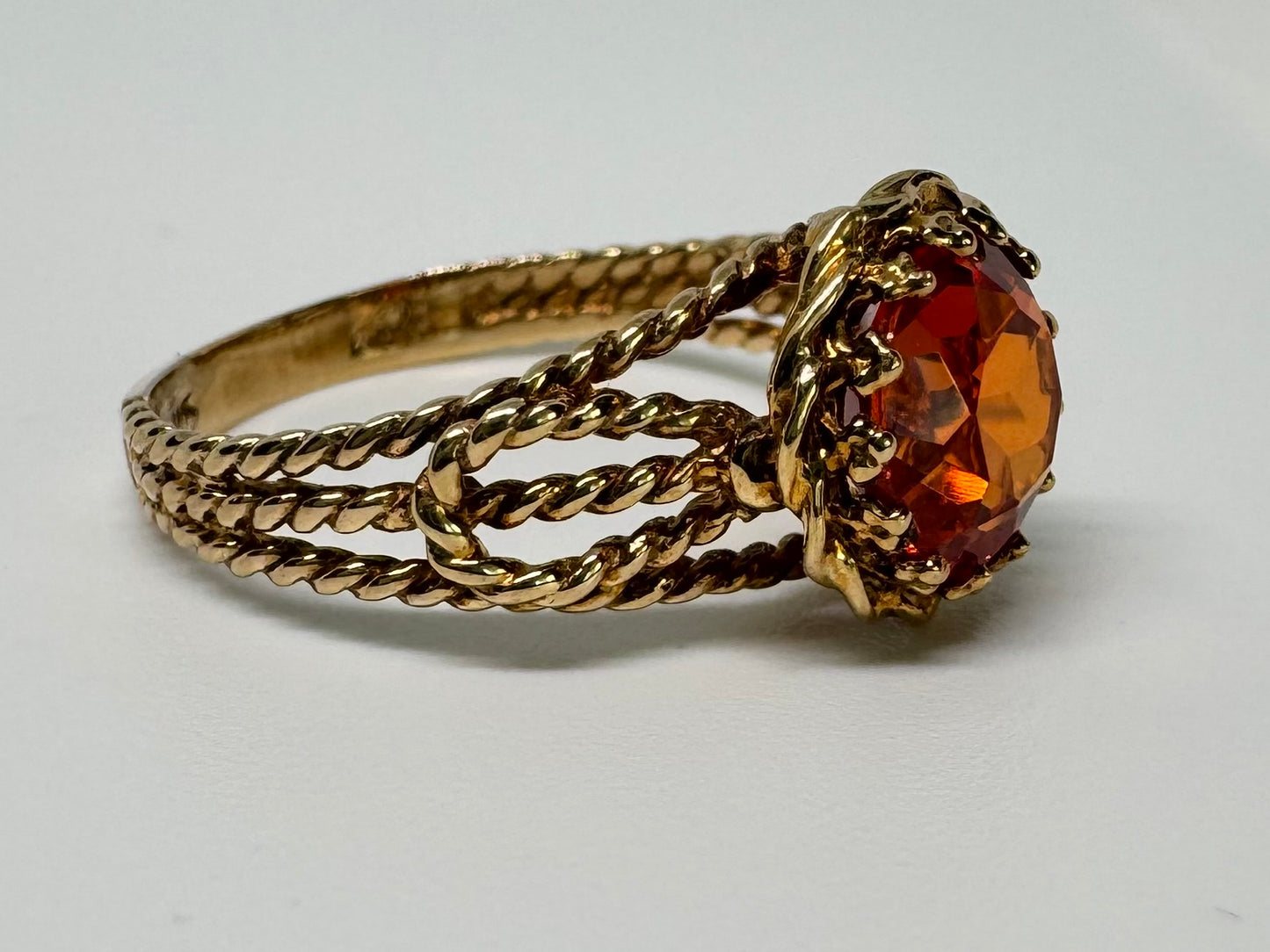 10K gold ring set with a vivid orange gemstone