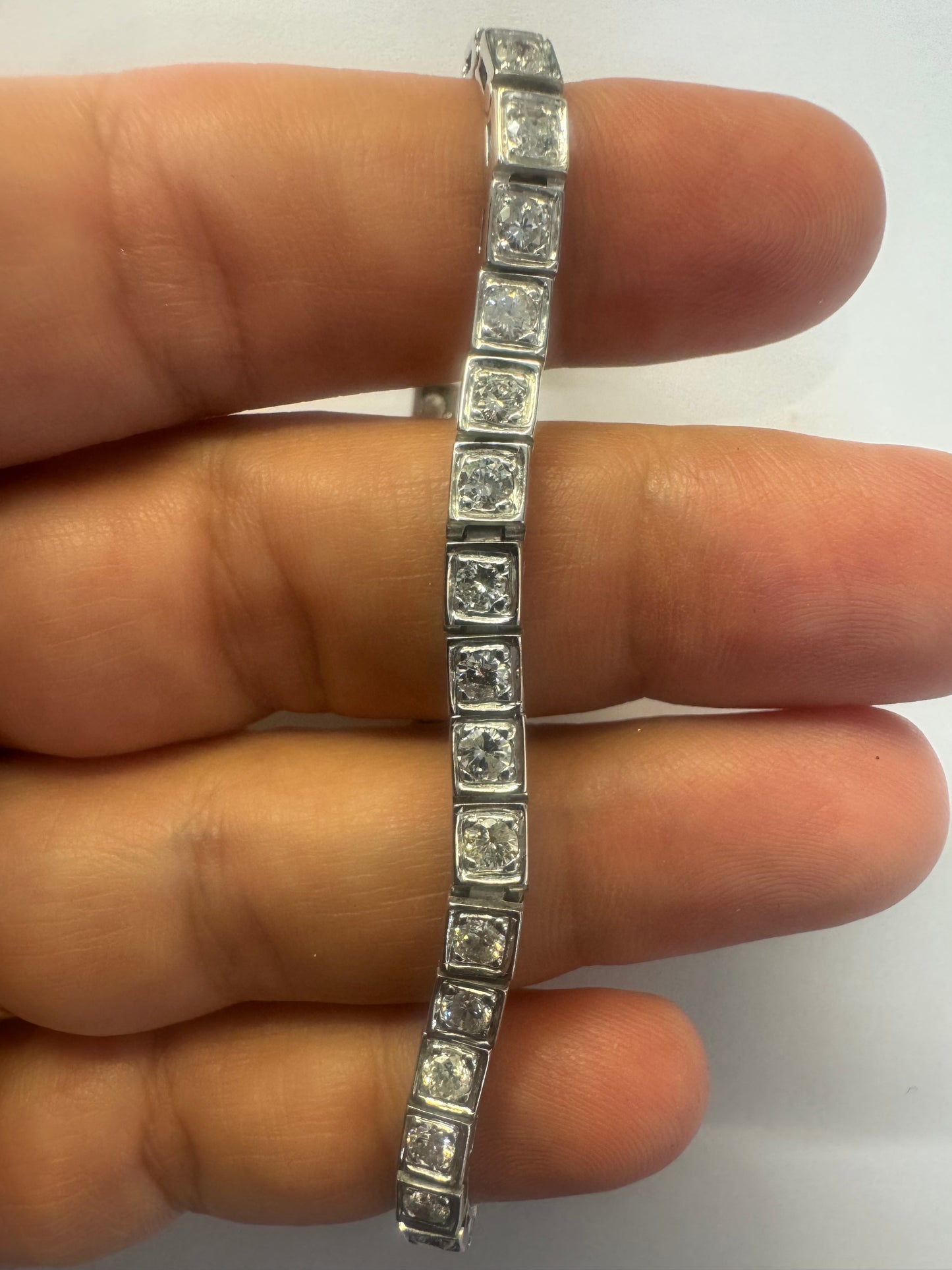18K gold tennis bracelet set with sparkling round-cut Diamonds in square bezel settings, creating a timeless and sophisticated look.