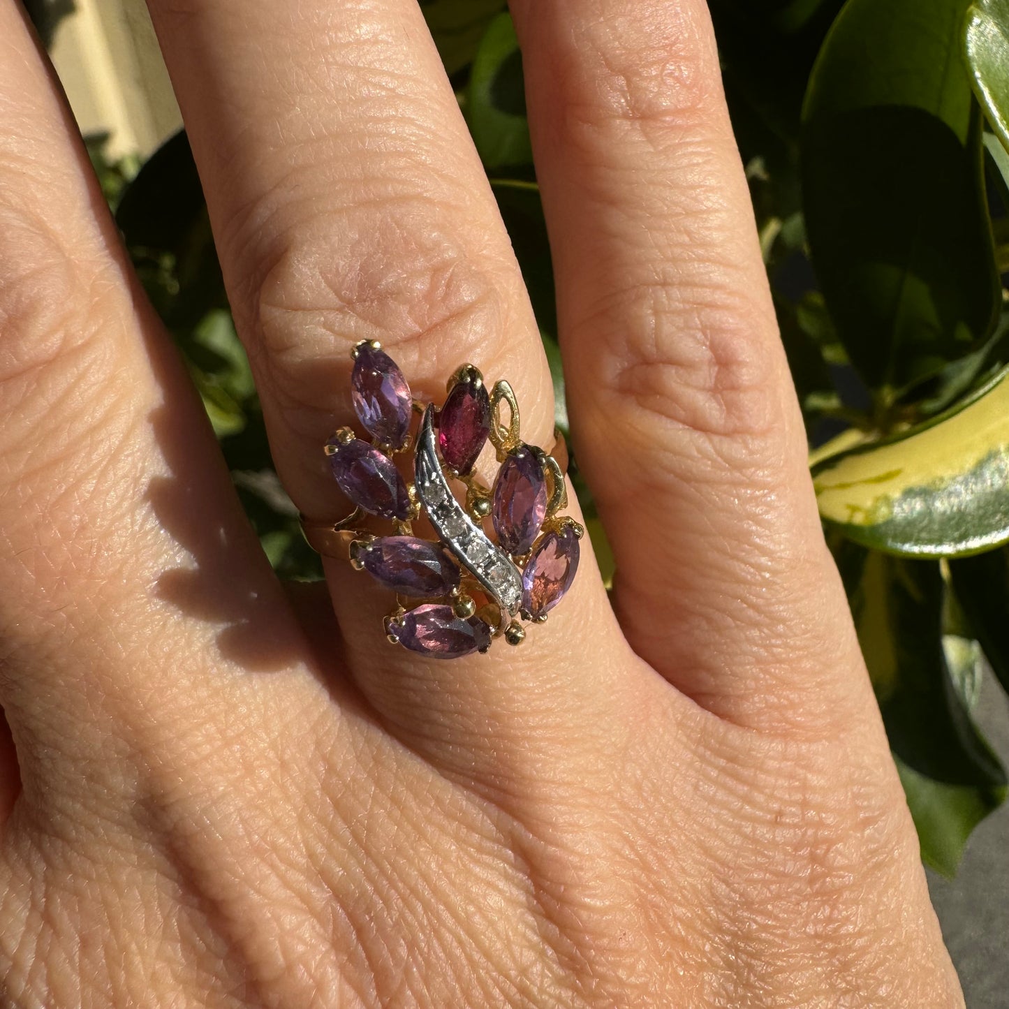 14K gold ring designed in a leaf motif, set with 7 marquise-cut Amethyst and accented by a curved line of sparkling Diamonds