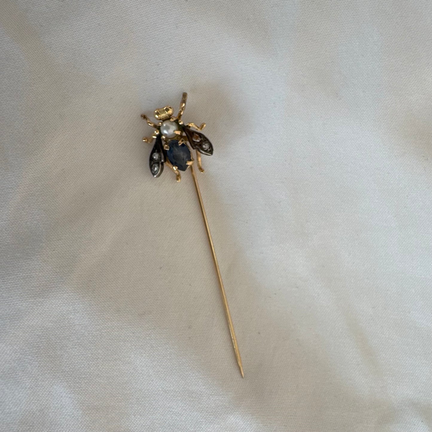 14K gold insect stick pin set with sapphire, seed pearl, and small diamonds.