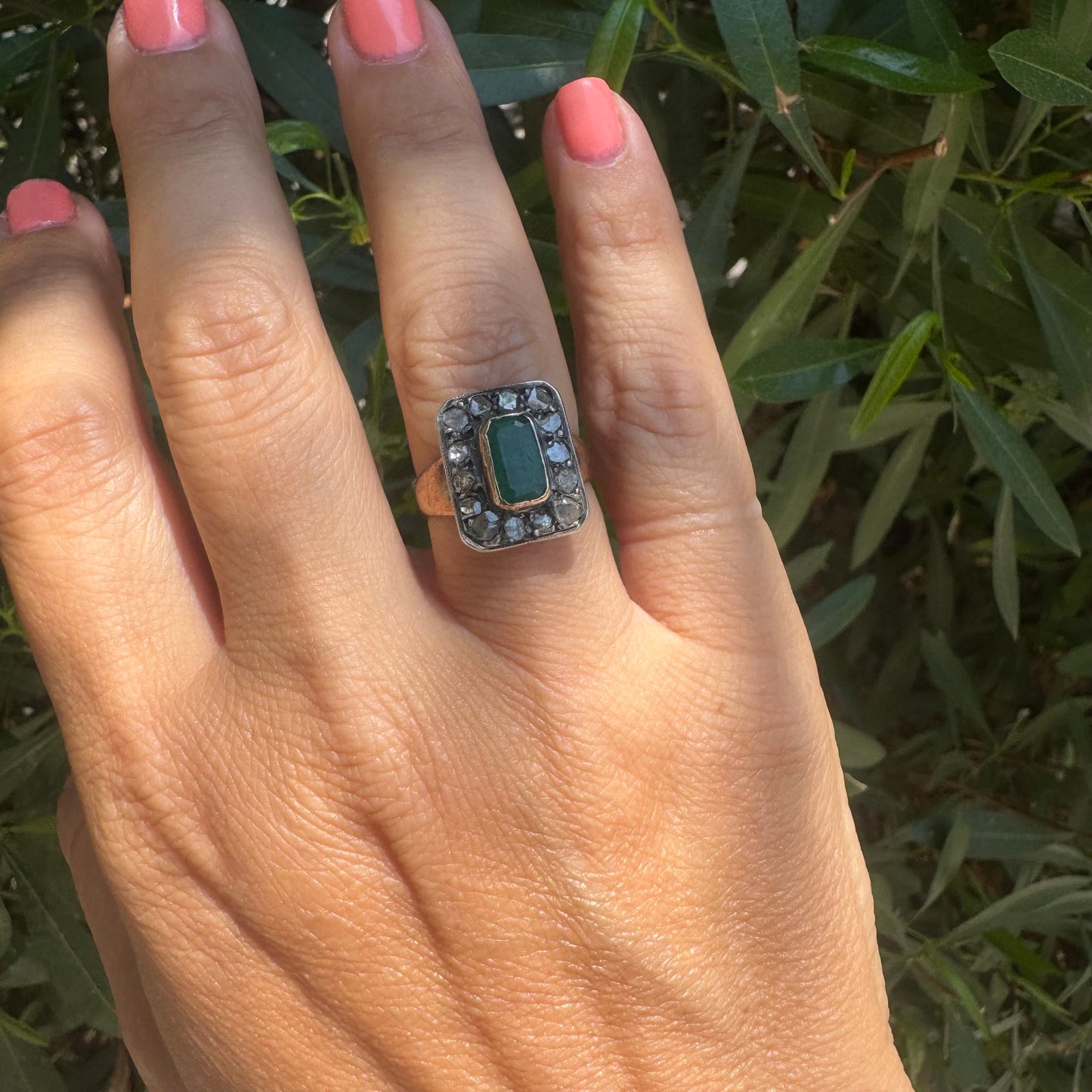 18K gold ring set with a rectangular Emerald and framed by a halo of rose-cut Diamonds