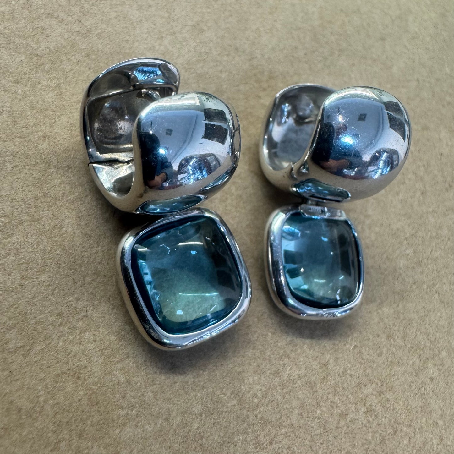 18K gold drop earrings featuring cushion-shaped Aquamarine in a smooth bezel setting, with a polished, modern design.