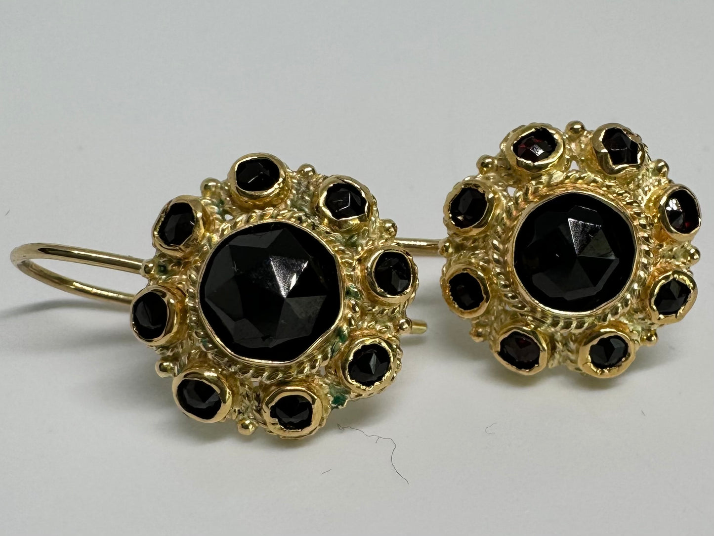 14K gold drop earrings set with deep red Garnets arranged in a bold circular design