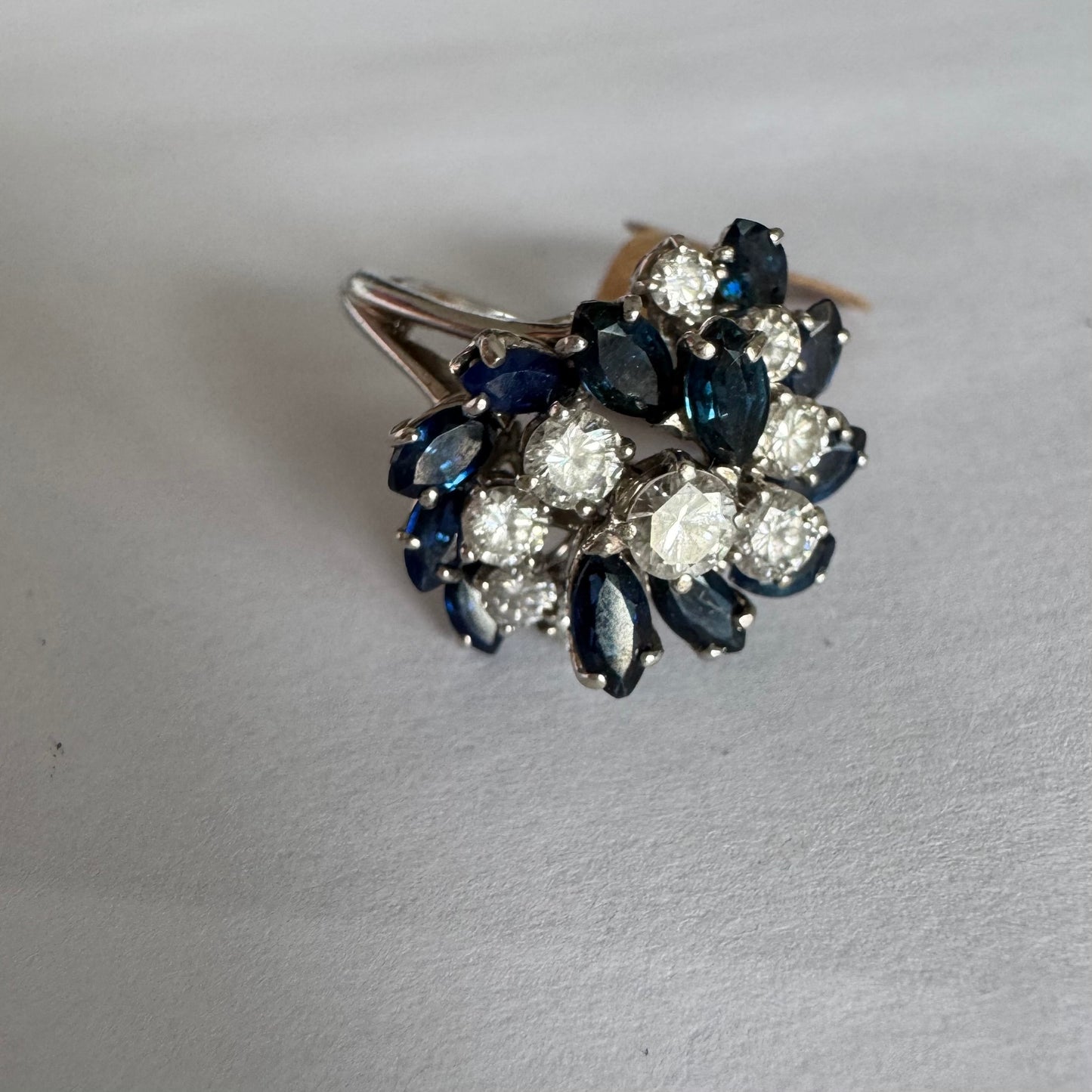18K white gold ring, set with marquise-cut blue Sapphires and round Diamonds, in a classic cluster design.