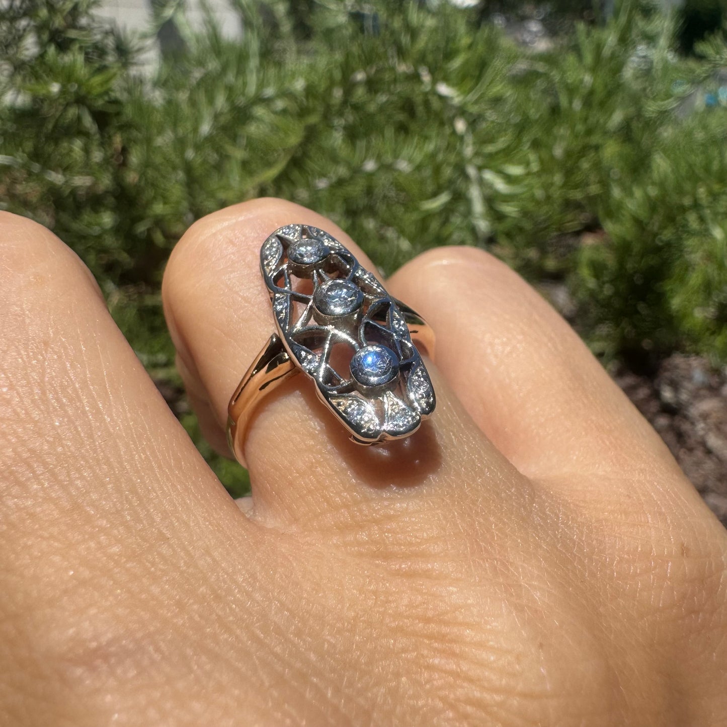 14K gold ring set with diamonds in an elongated openwork design