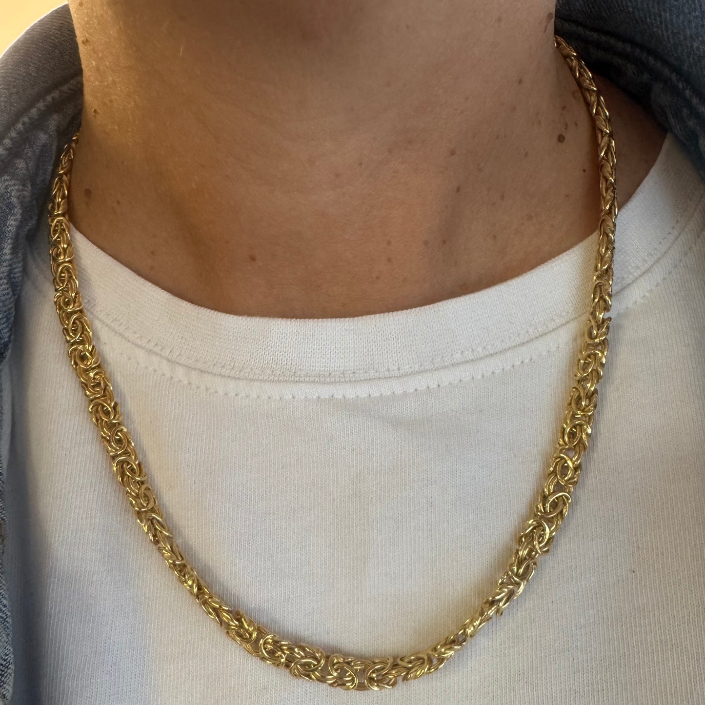 14K yellow gold necklace featuring an intricate, twisted link design