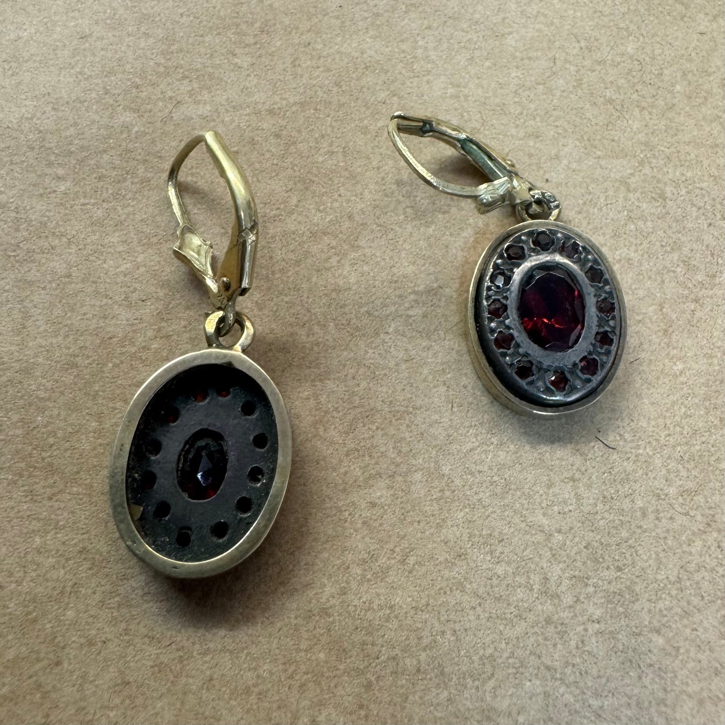 14K gold drop earrings set with deep red oval Garnets surrounded by smaller stones Garnets.