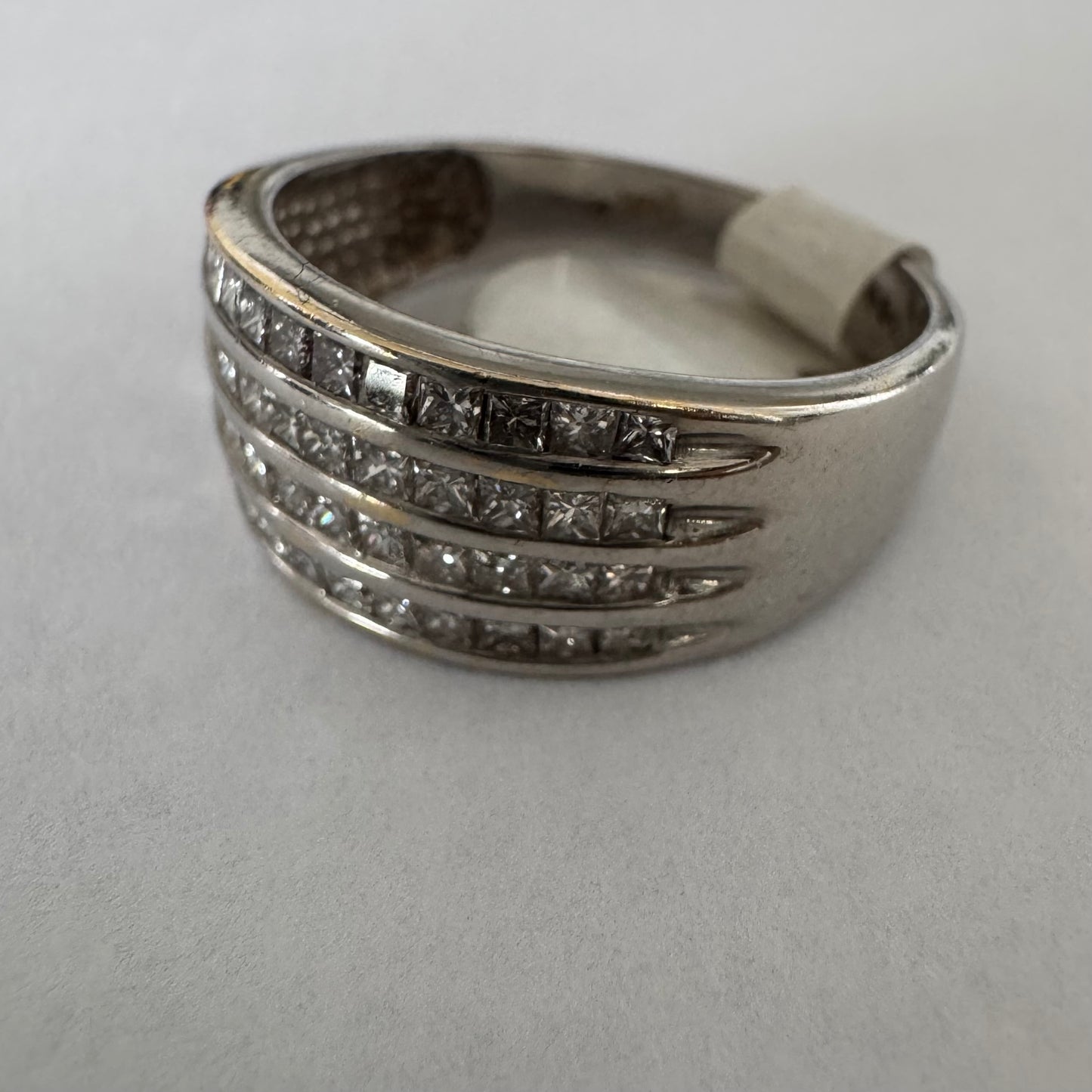 14K gold ring set with four parallel rows of princess-cut Diamonds.