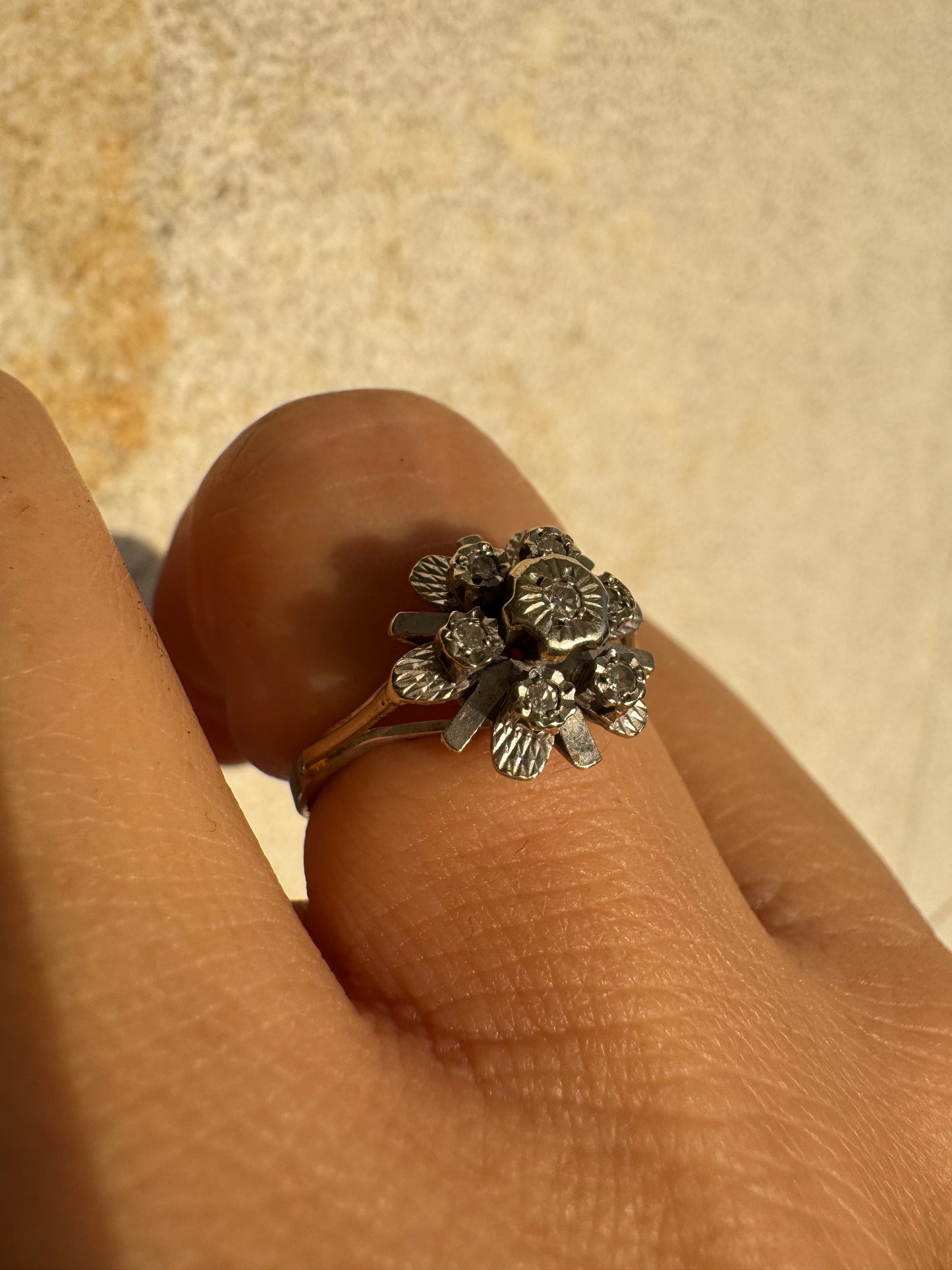 18K gold floral ring adorned with delicate diamond accents