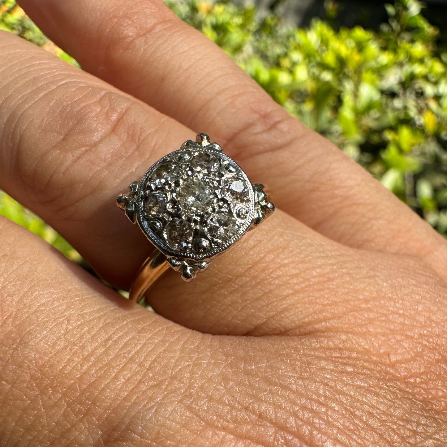 14K gold ring set with an old-cut Diamond at its center, encircled by a pavé cluster of smaller Diamonds in a round, ornate setting.
