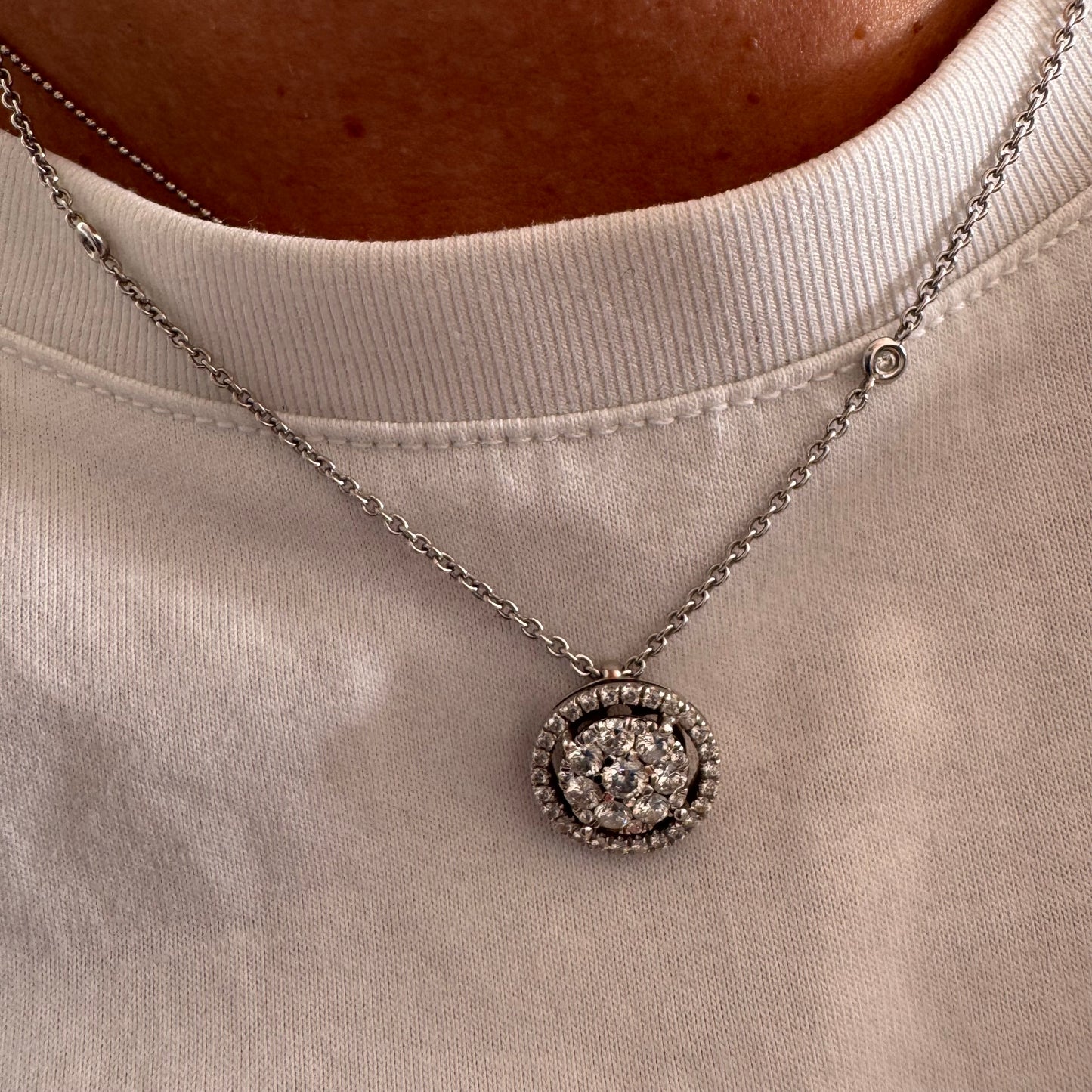14K gold necklace featuring a round pendant set with a cluster of sparkling Diamonds