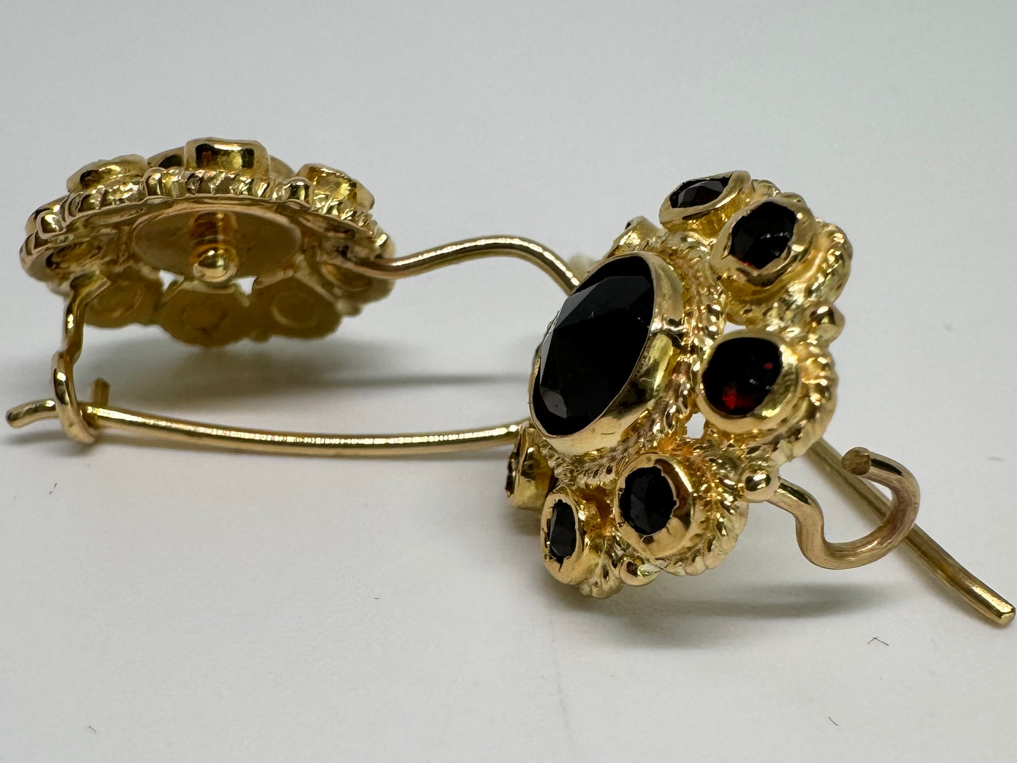 14K gold drop earrings set with deep red Garnets arranged in a bold circular design