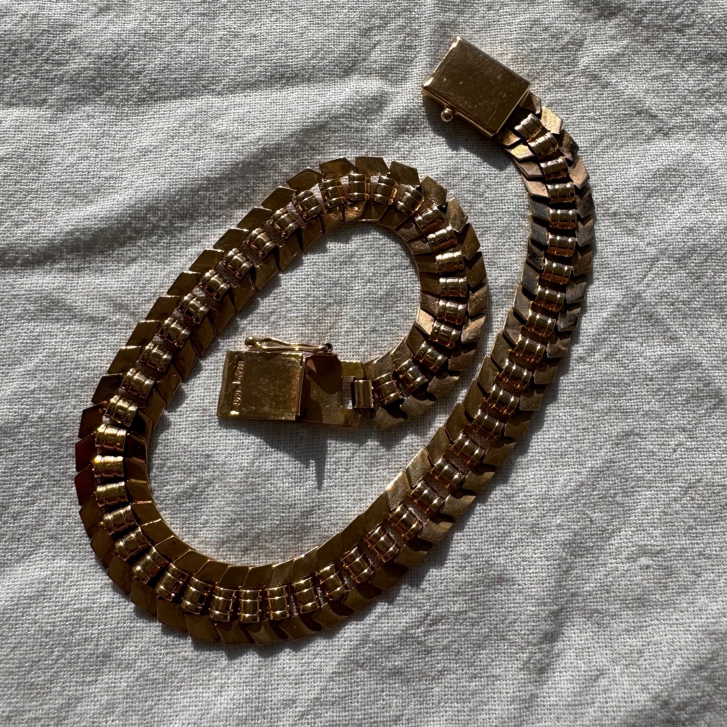 14K gold bracelet with a bold, flexible link design and a secure box clasp.