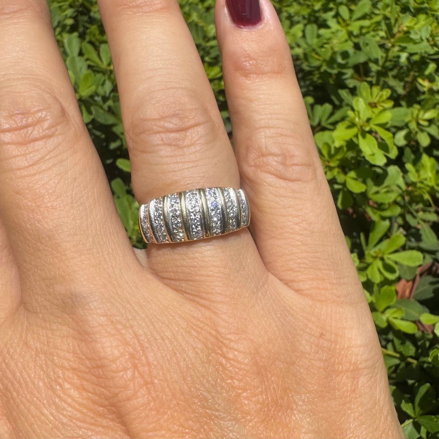 18K gold ring featuring multiple horizontal rows of sparkling Diamonds.