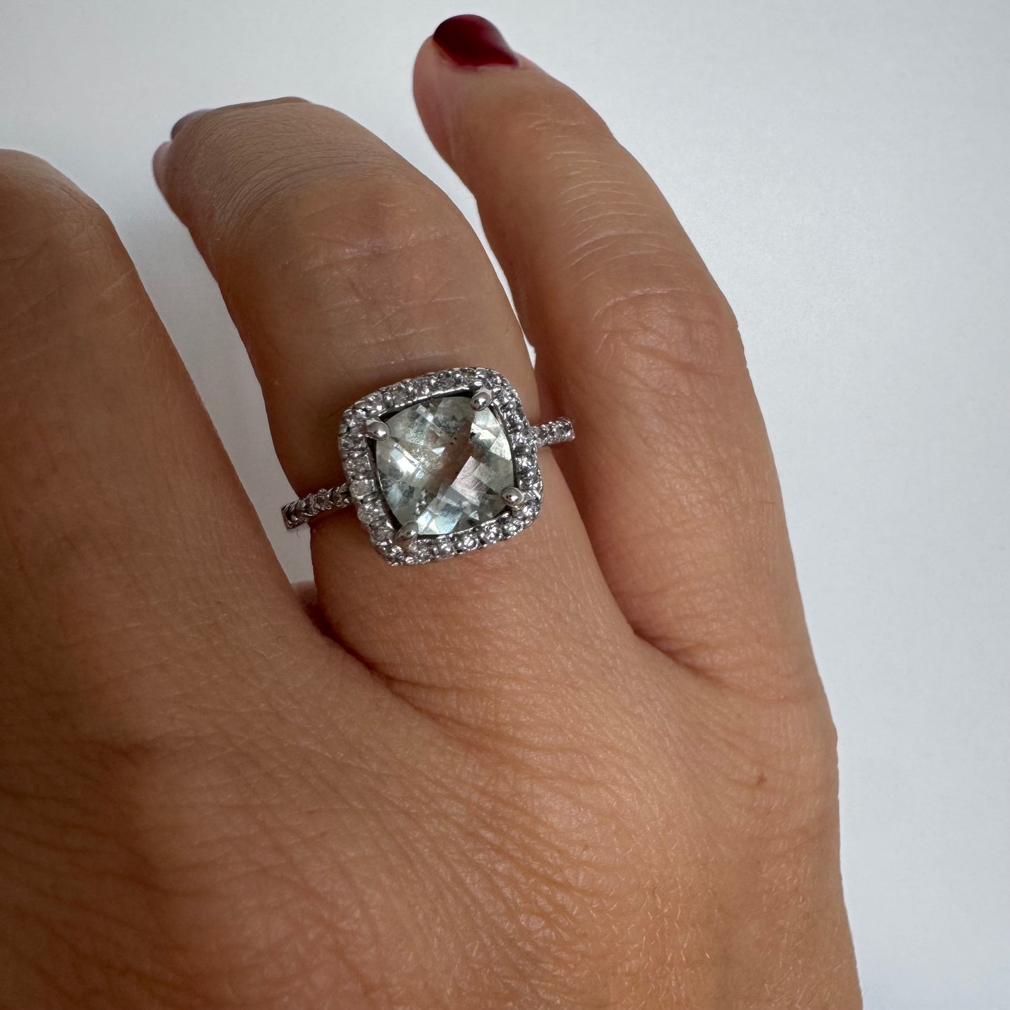 14K white gold ring featuring a cushion-cut light blue Aquamarine set in a sparkling double halo of round-cut Diamonds.