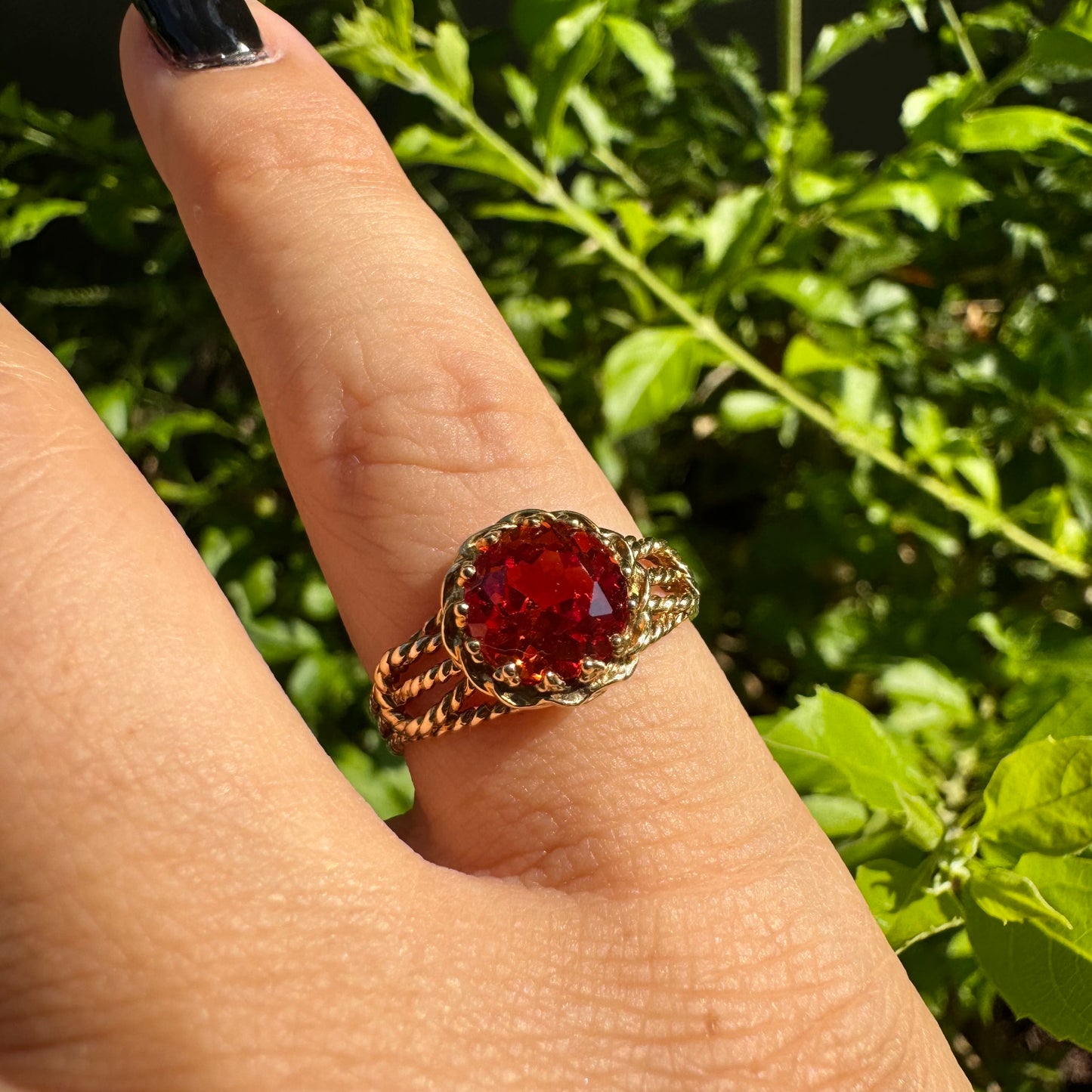 10K gold ring set with a vivid orange gemstone
