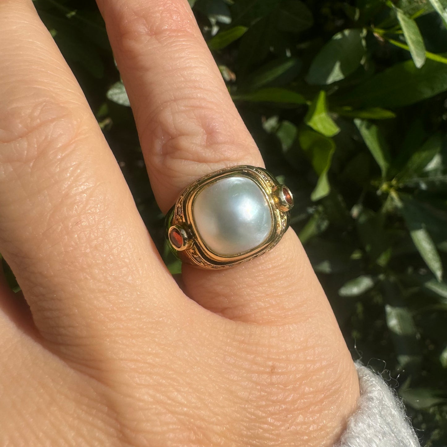 18K gold ring set with a luminous baroque Pearl, flanked by deep red Tourmaline cabochons & Diamonds