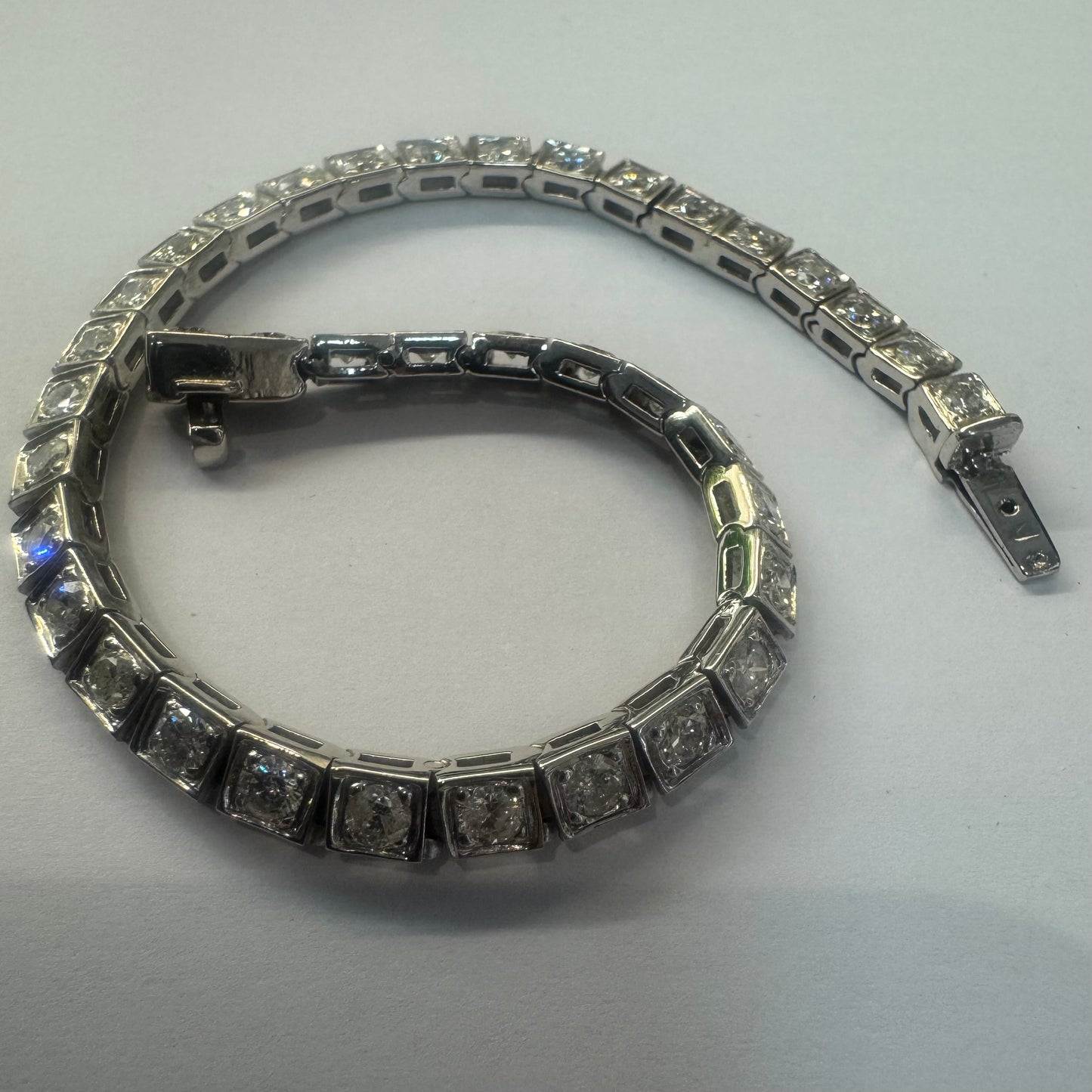 18K gold tennis bracelet set with sparkling round-cut Diamonds in square bezel settings, creating a timeless and sophisticated look.