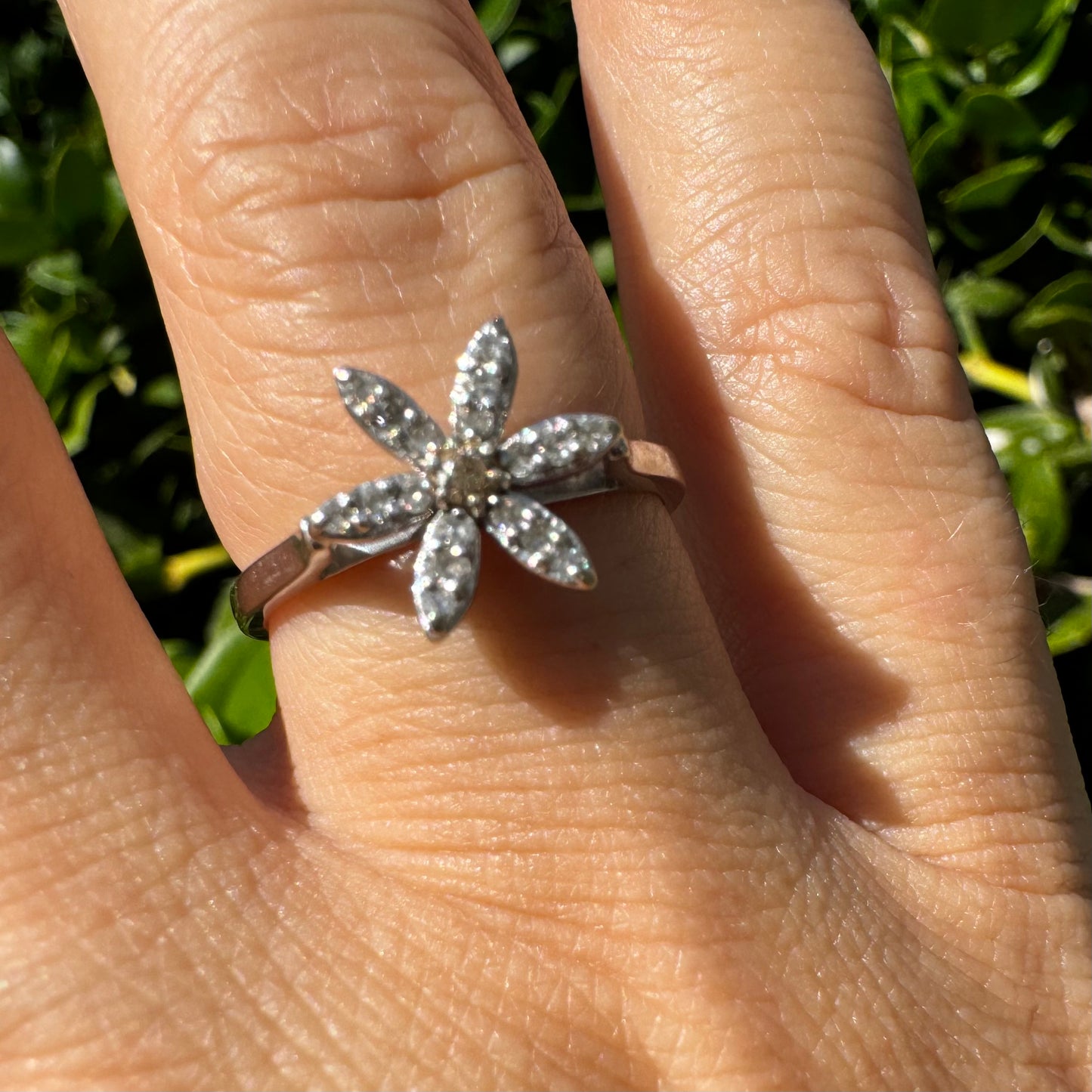 14K gold ring set with a floral design with six petal-shaped segments, each pavé-set with shimmering Diamonds