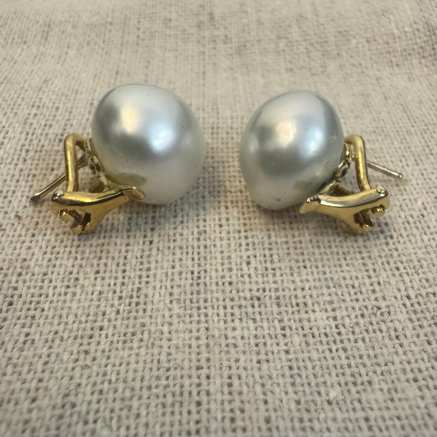 14K gold stud earrings set with large & luminous white Pearls.