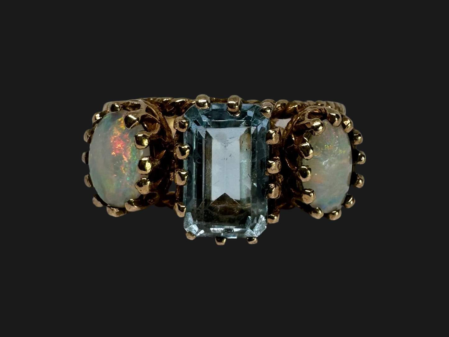 10K gold ring set with a light blue Aquamarine flanked by two dreamy Opals