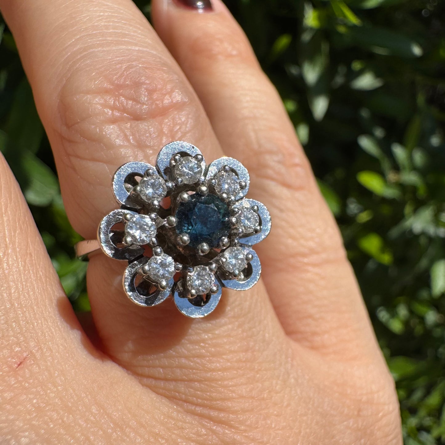 14K gold floral ring set with a round deep blue Sapphire at its center & Diamonds